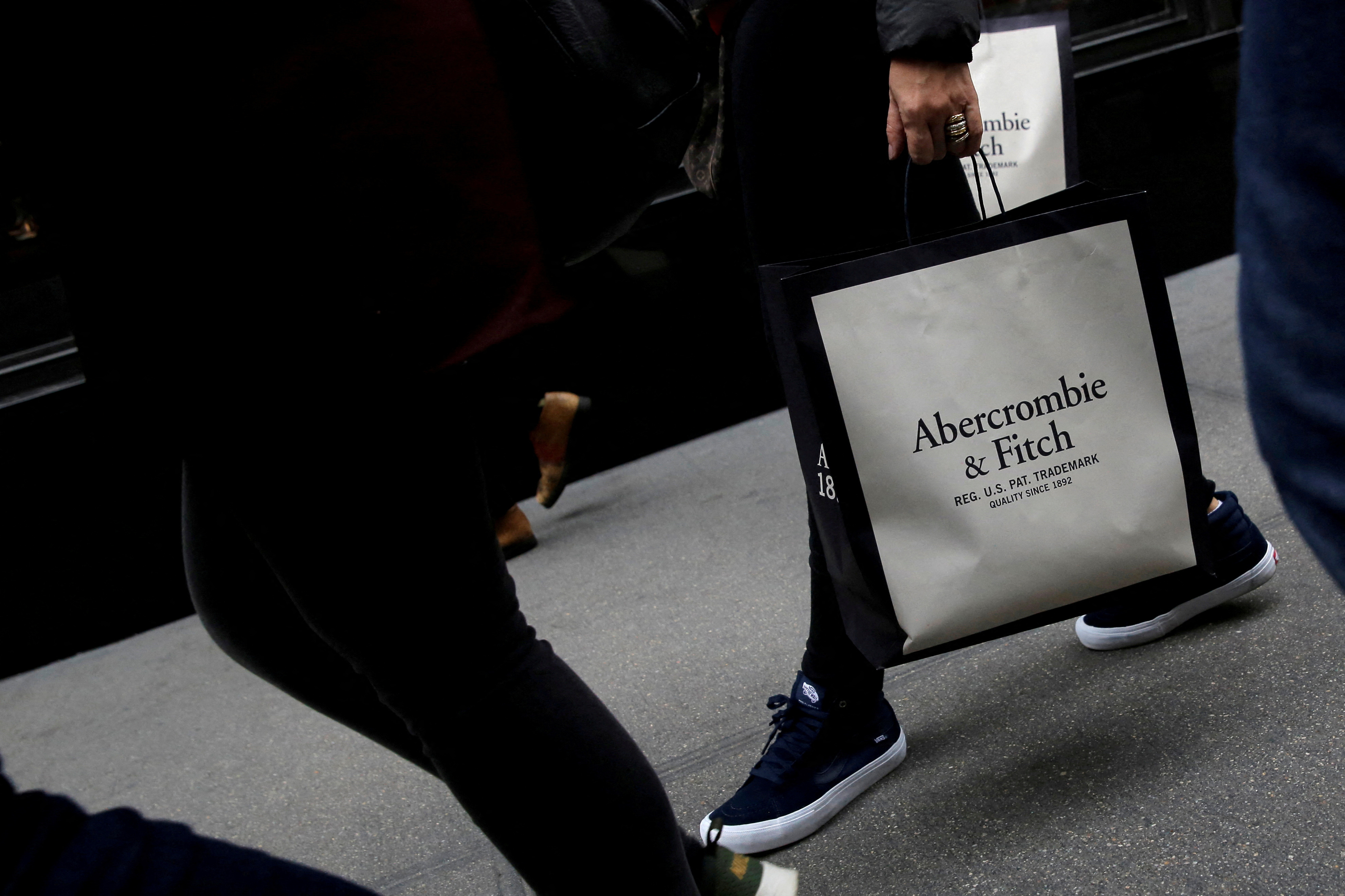 A person carries a bag from the Abercrombie & Fitch store on Fifth Avenue in Manhattan, New York City, U.S.