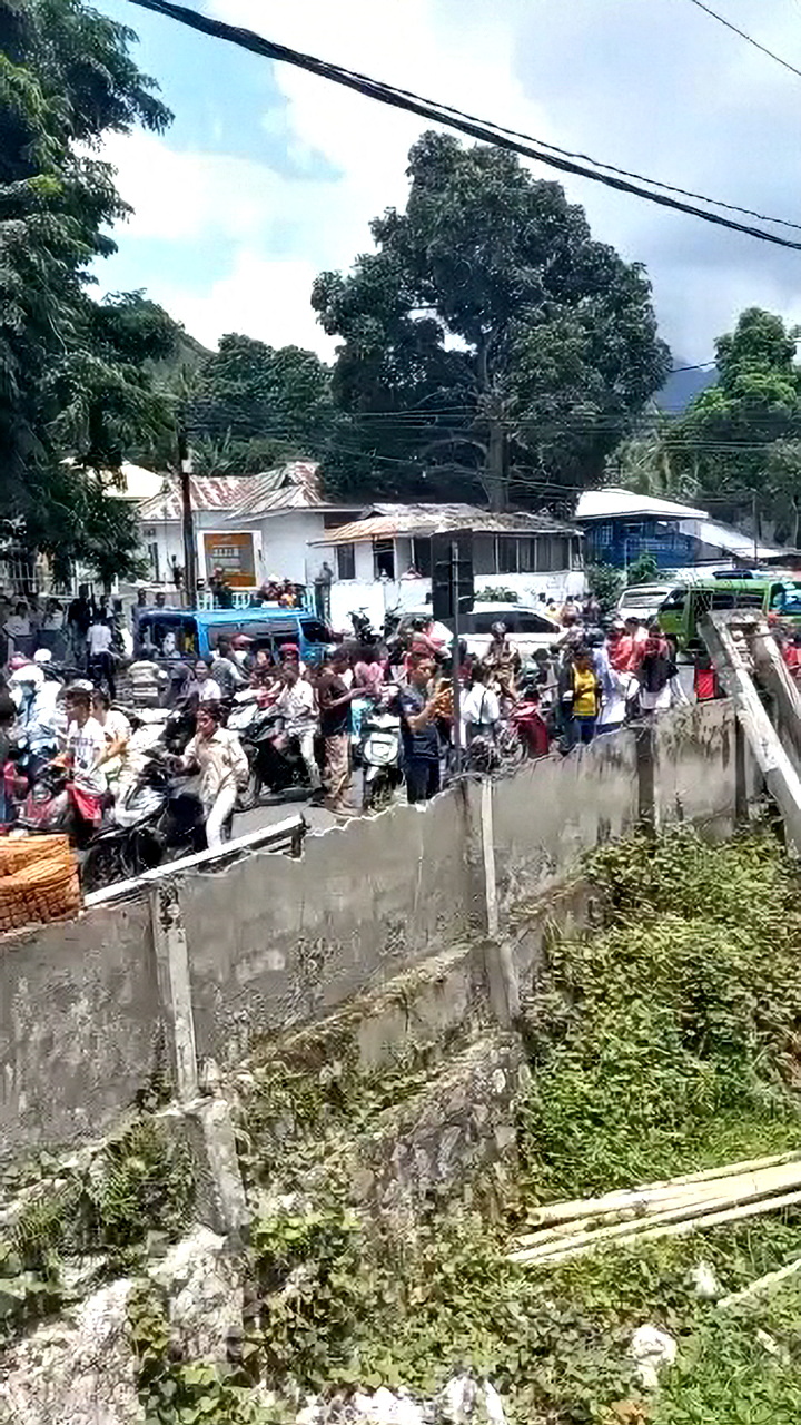 A still image from a social media video shows people on a street after an earthquake in Maumere, Indonesia
