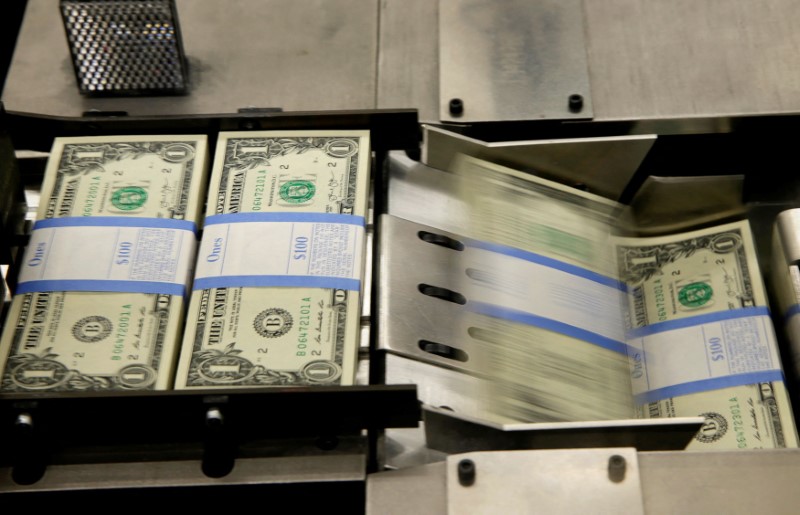United States one dollar bills are put in packaging bands during production at the Bureau of Engraving and Printing in Washington