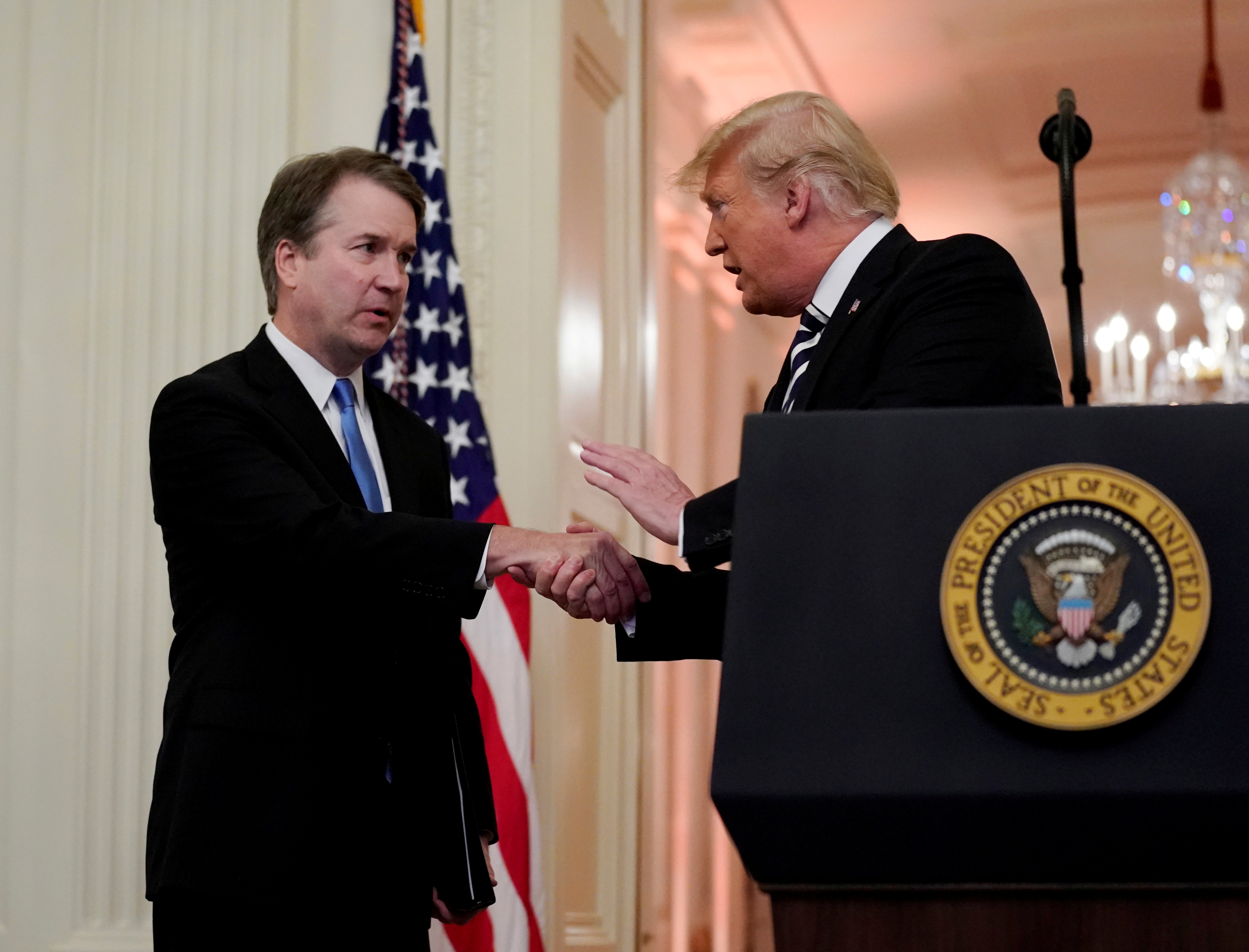 U.S. Supreme Court Associate Justice Brett Kavanaugh talks with U.S. President Donald Trump during his ceremonial public swearing-in at the East Room of the White House in Washington, U.S., October 8, 2018.  REUTERS/Jonathan Ernst/File Photo