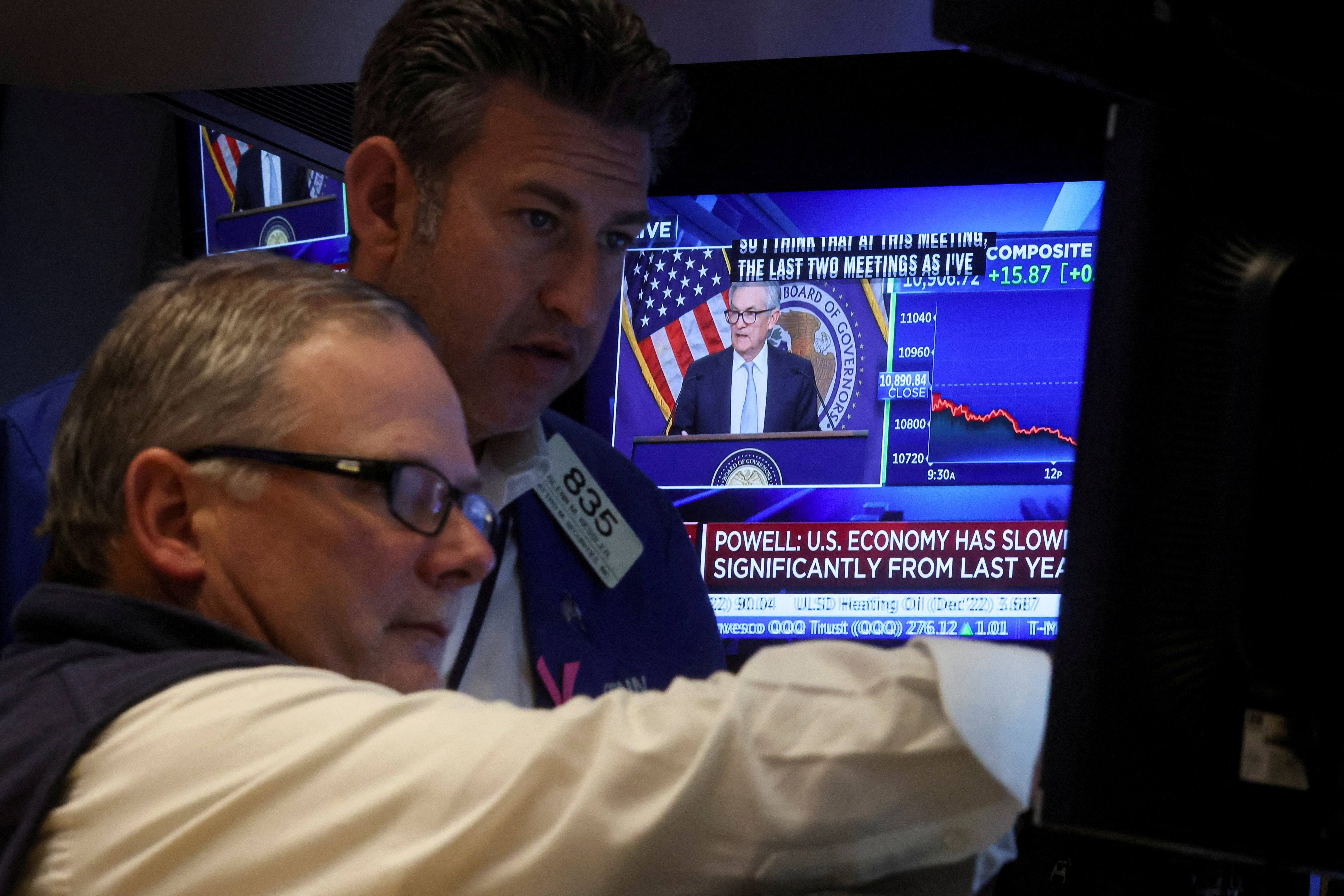 Traders react as Federal Reserve Chair Powell speaks on a screen on the floor of the NYSE in New York
