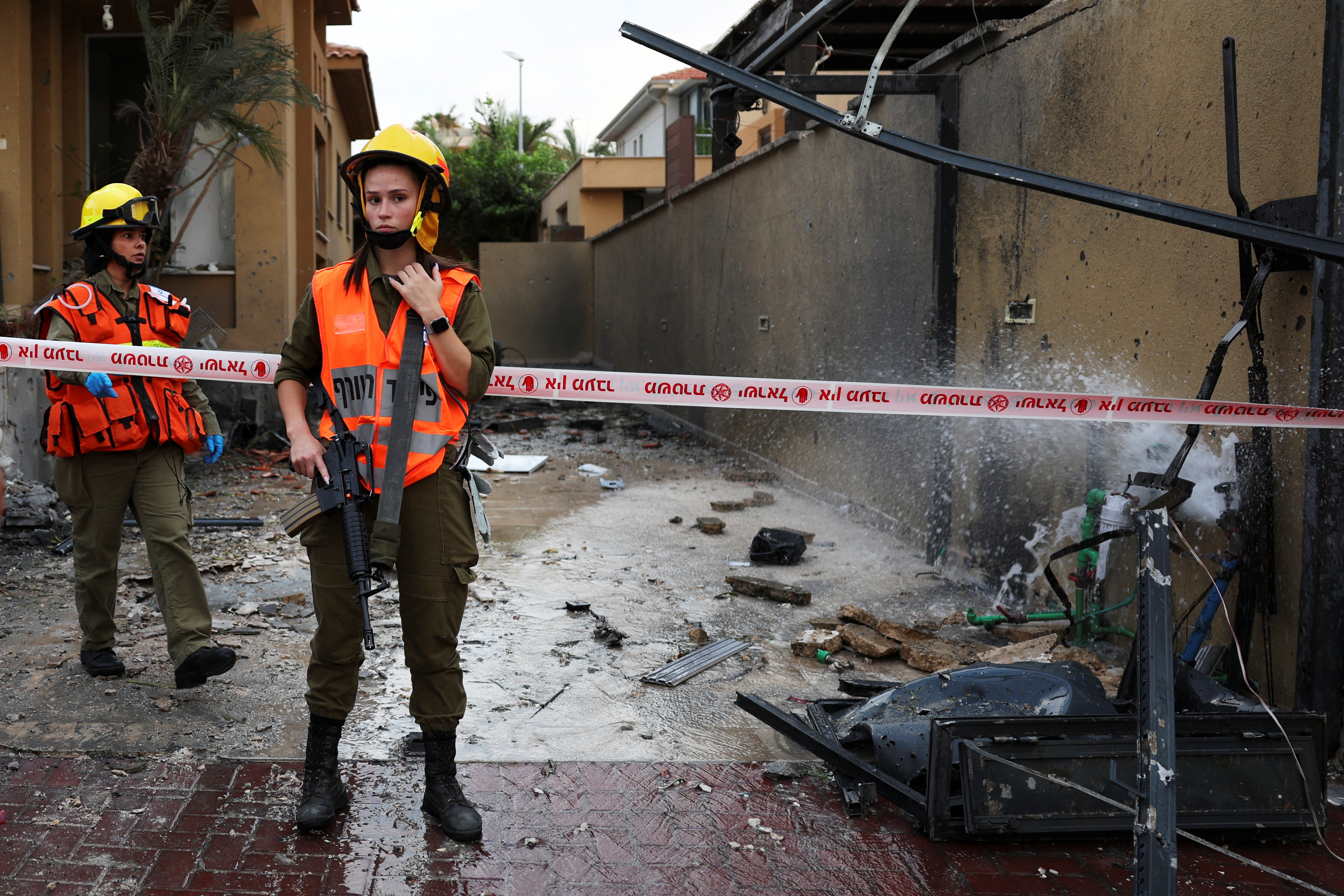 Israeli soldiers stand guard near damage caused by a rocket after if was fired from the Gaza Strip towards Israel, in Ashkelon