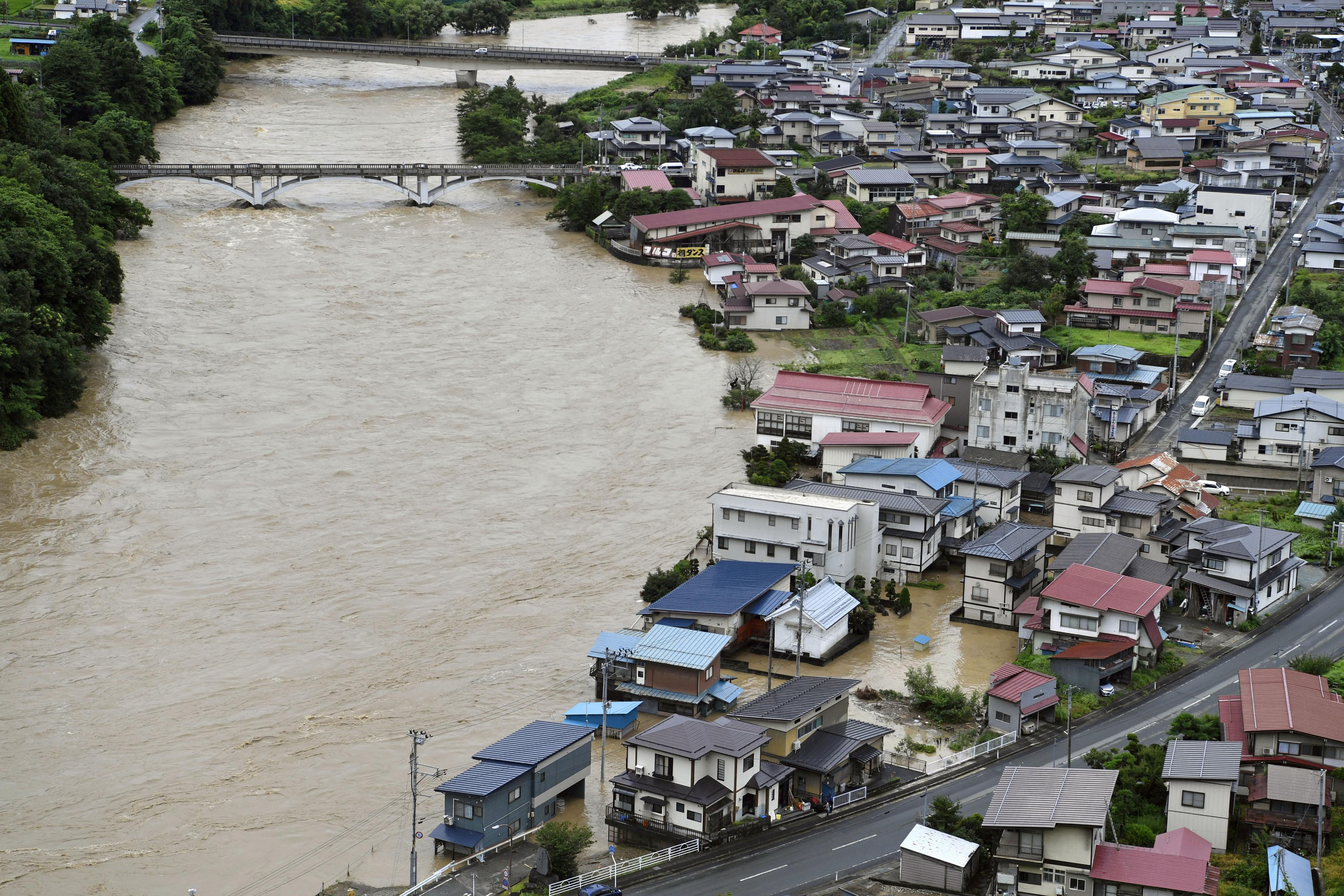 A view shows a submerged residential area caused by a flood of the Mogami river in Oe town, Yamagata prefecture