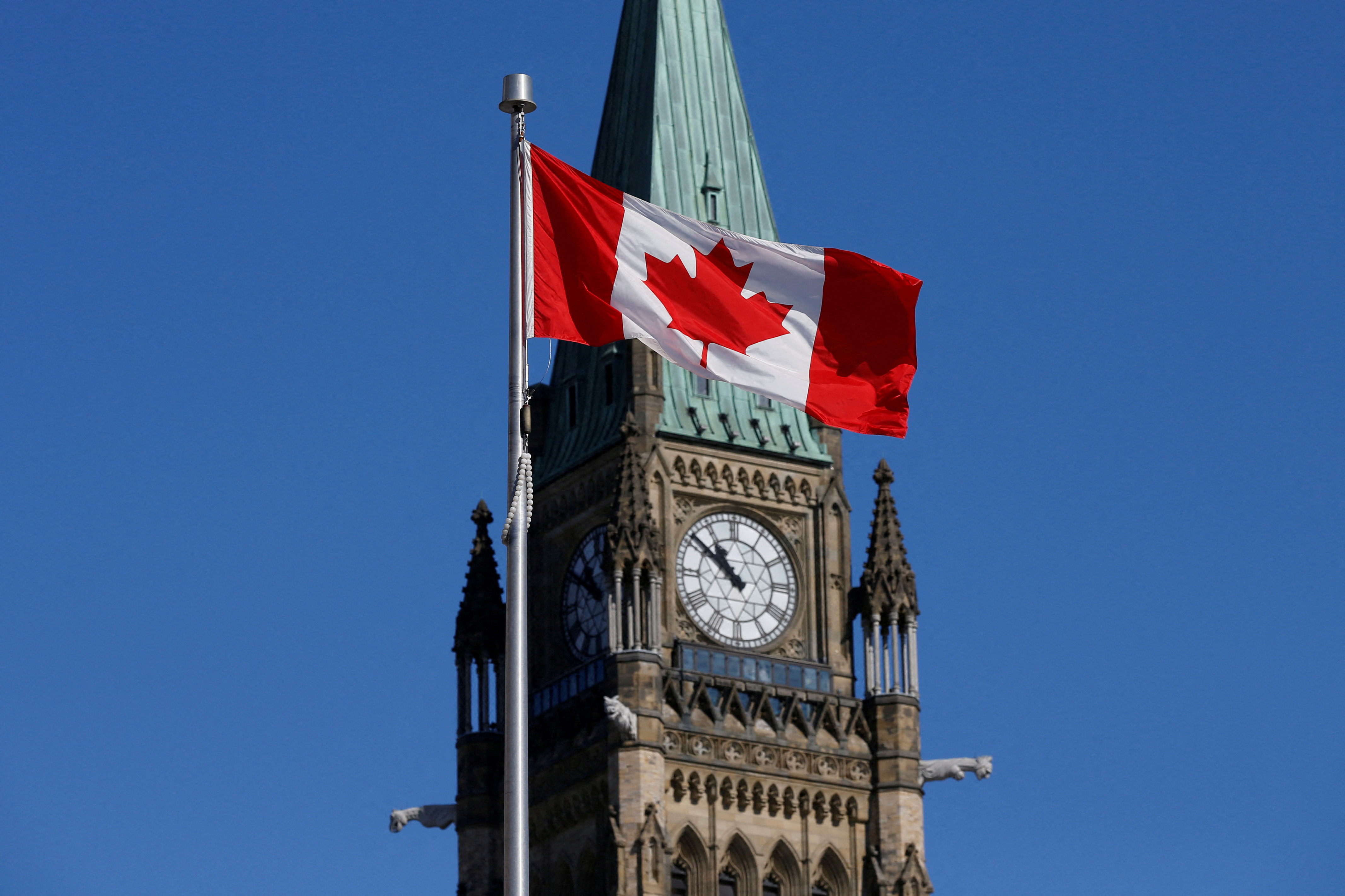 Canadian flag flies in front of the Peace Tower on Parliament Hill in Ottawa