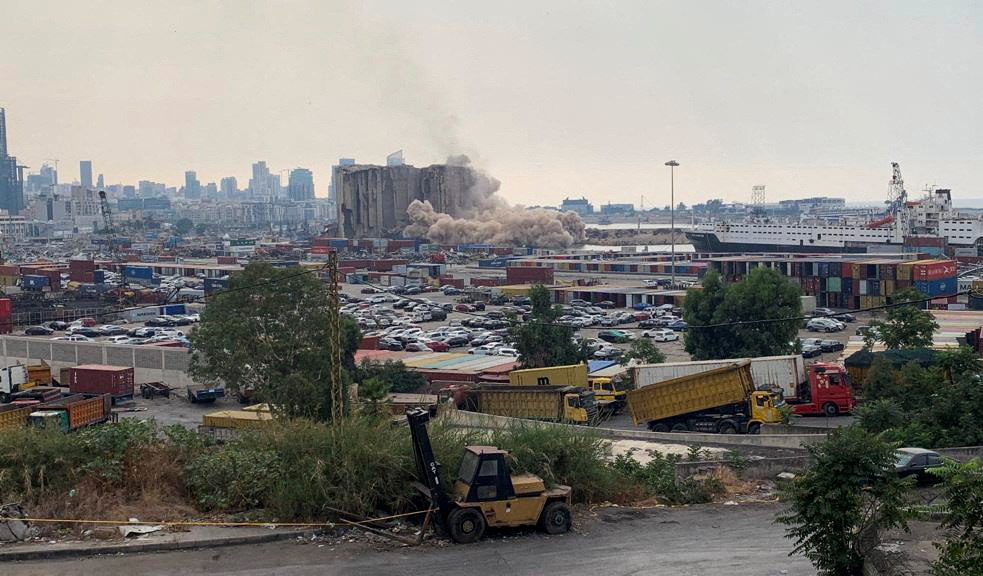 Smoke and dusk rises as part of Beirut grain silos damaged in August 2020 explosion collapses in Beirut