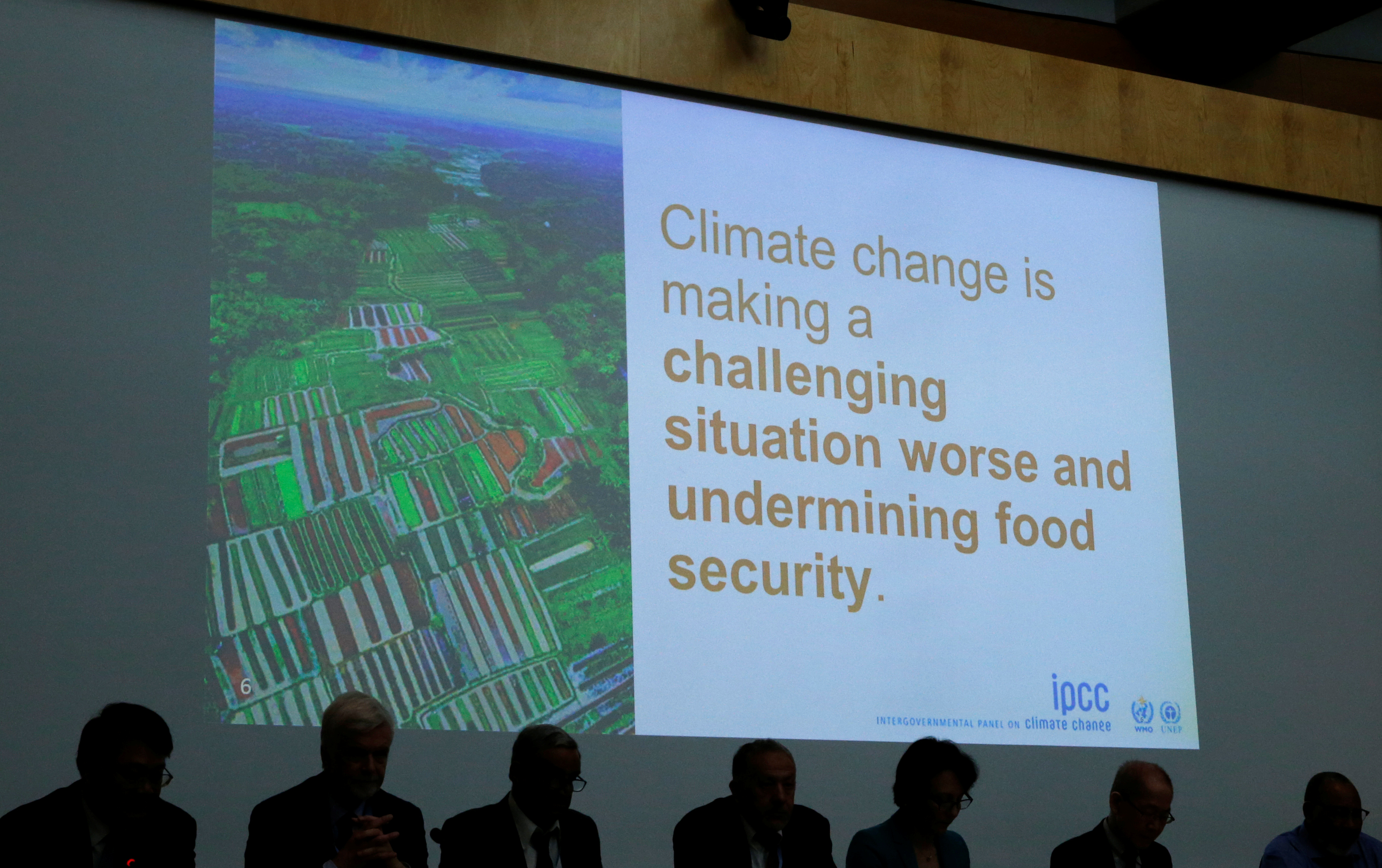 A slide is pictured behind members of the IPCC during a news conference in Geneva