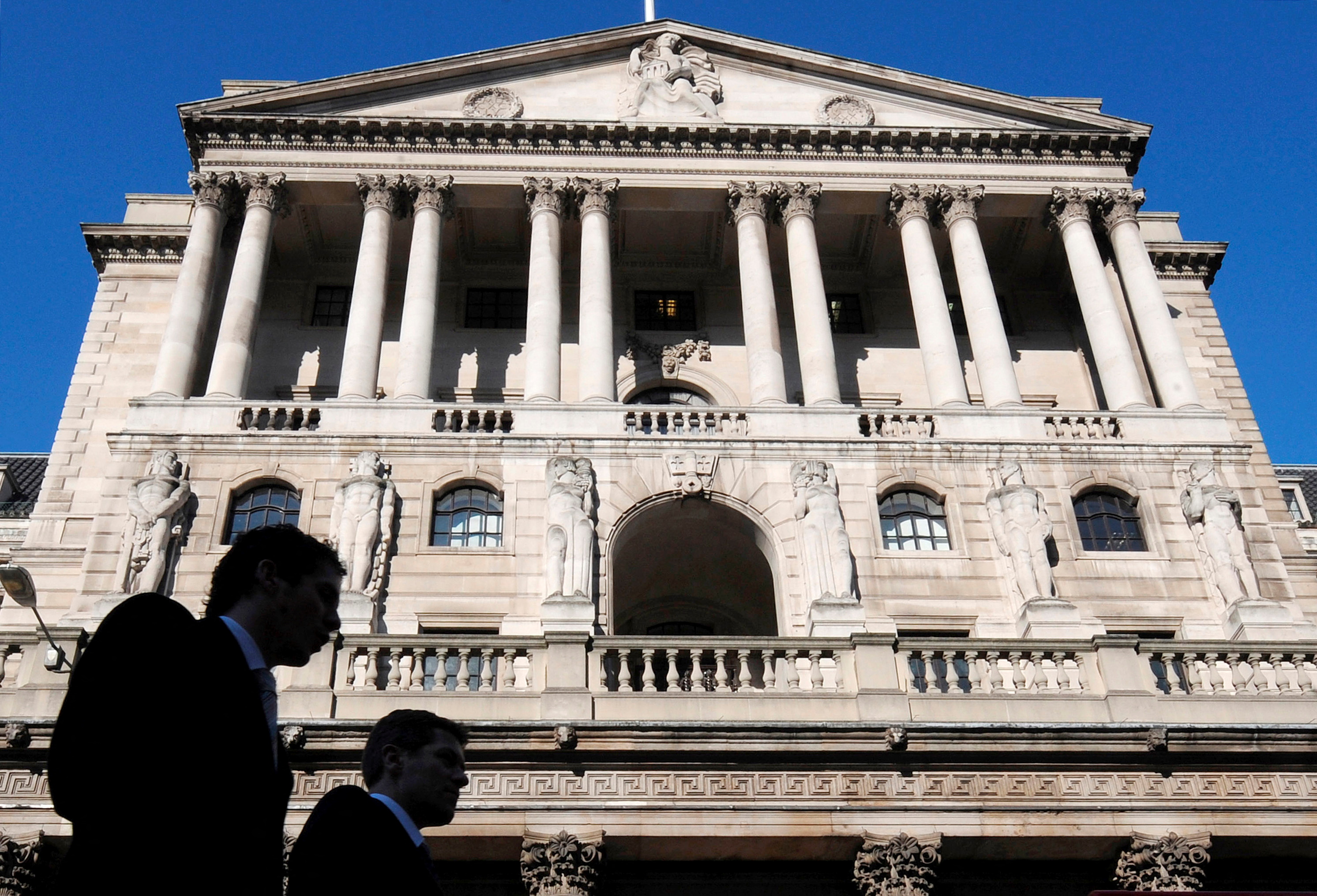 City workers walk past the Bank of England in London