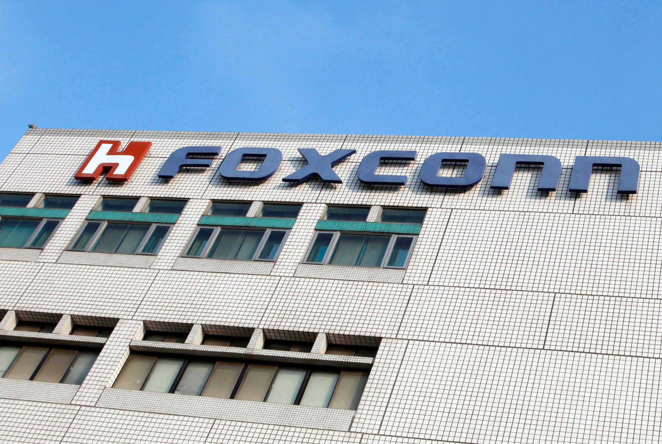 FILE PHOTO: The Foxconn logo is seen on the headquarters building in Tucheng, Taipei County