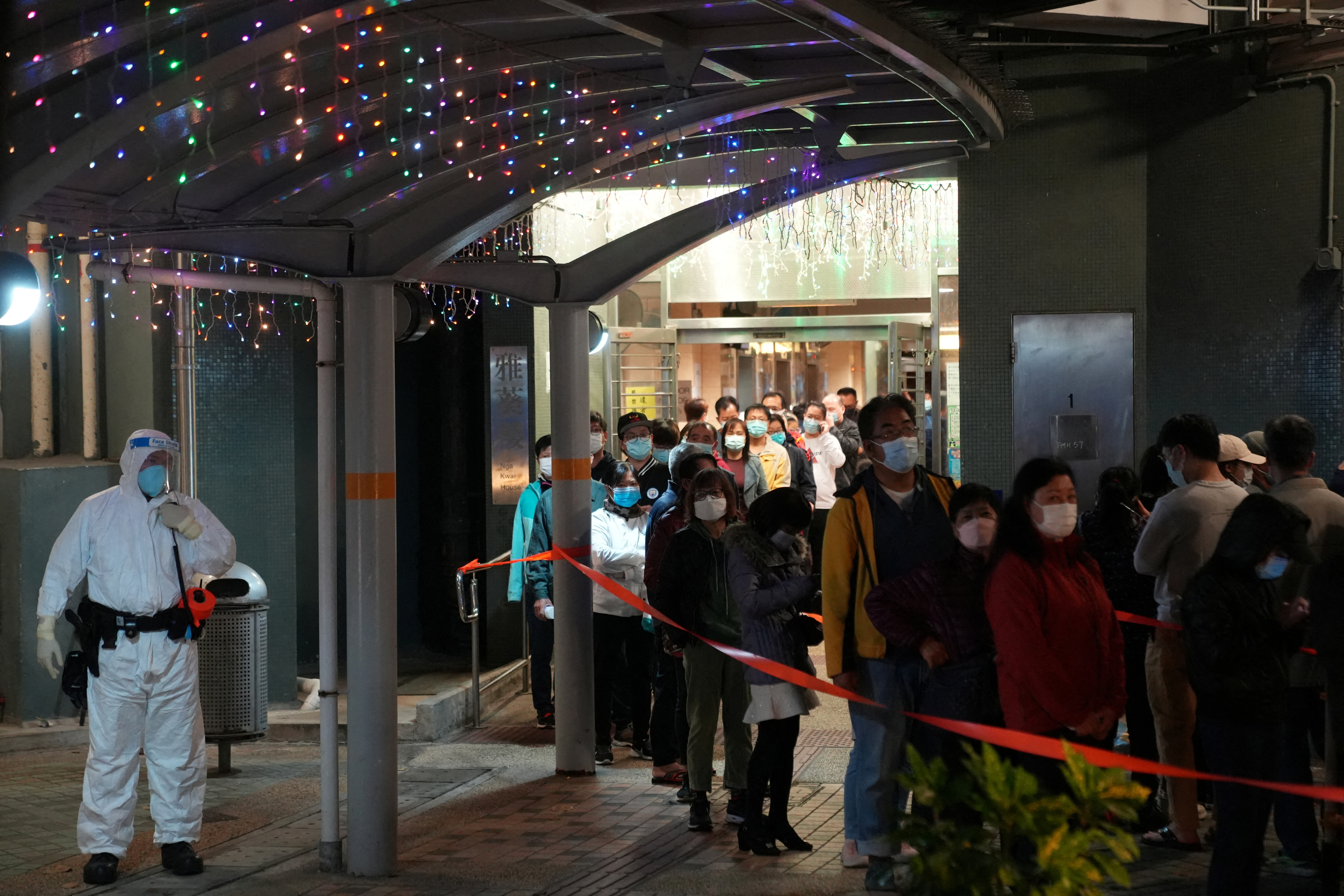 Residents queue for taking nucleic acid test following a new COVID-19 outbreak, in Hong Kong