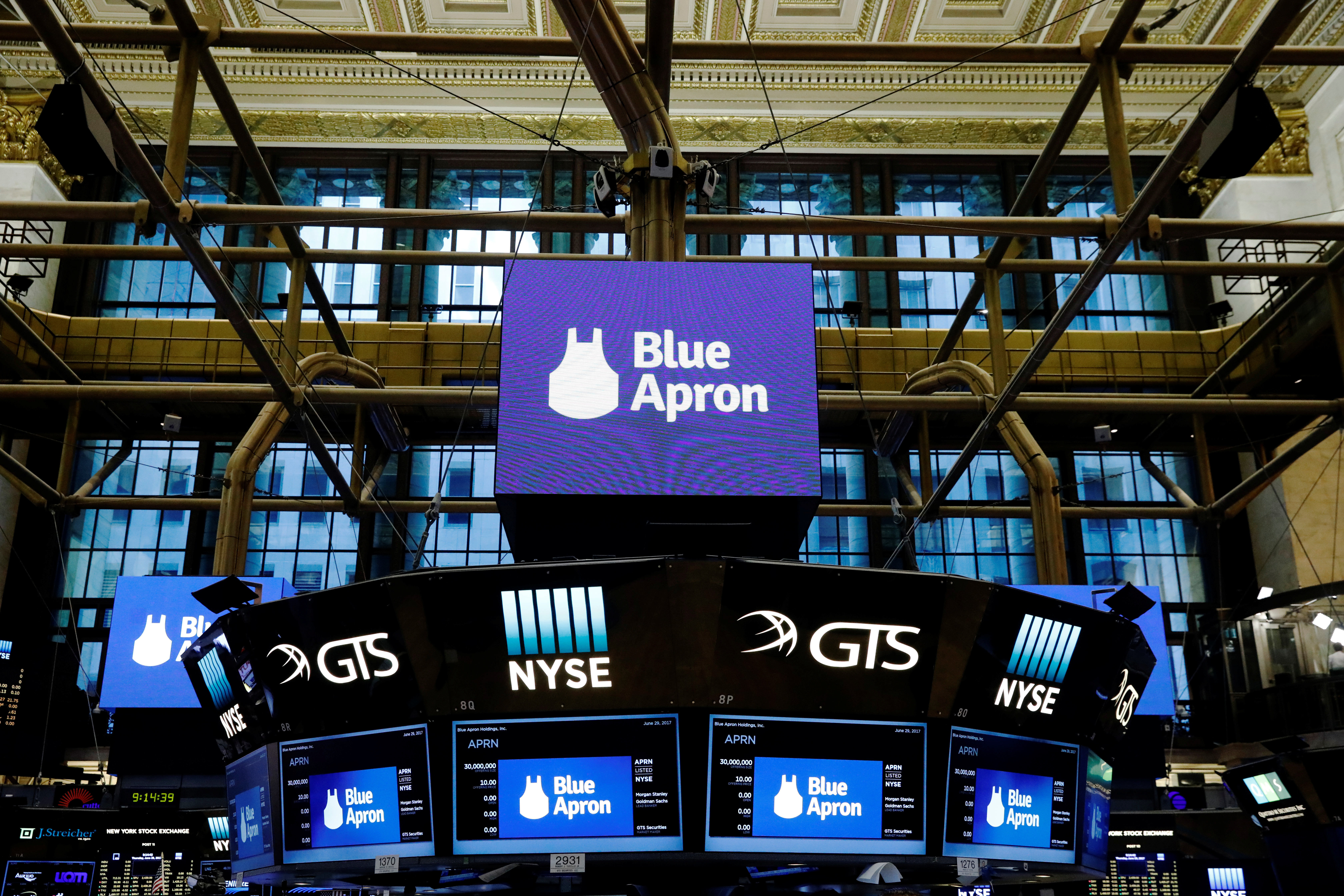The logo of Blue Apron is shown on screens above the floor of the New York Stock Exchange before the company's IPO in New York