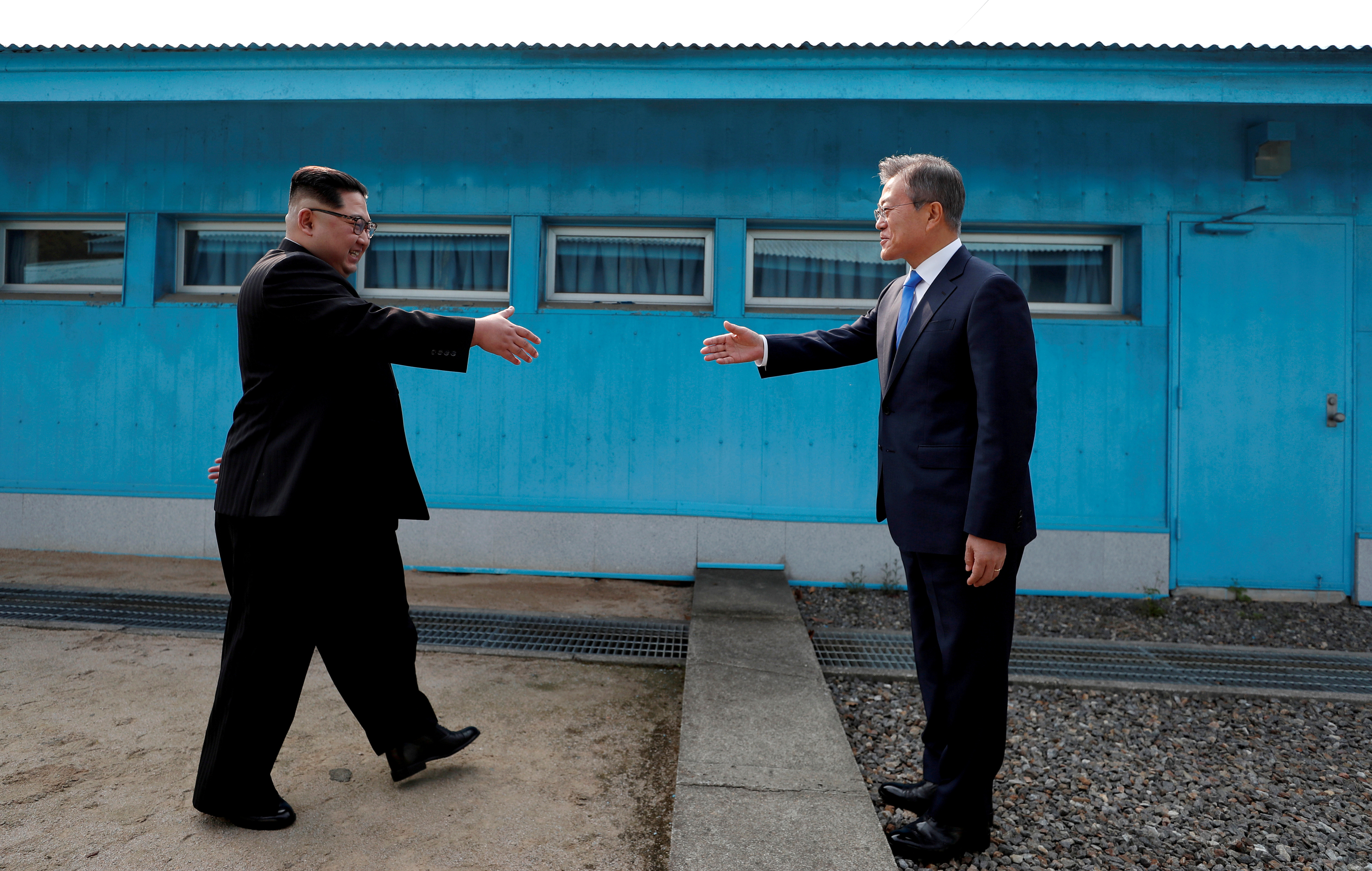 South Korean President Moon Jae-in and North Korean leader Kim Jong Un shake hands at the truce village of Panmunjom inside the demilitarized zone separating the two Koreas