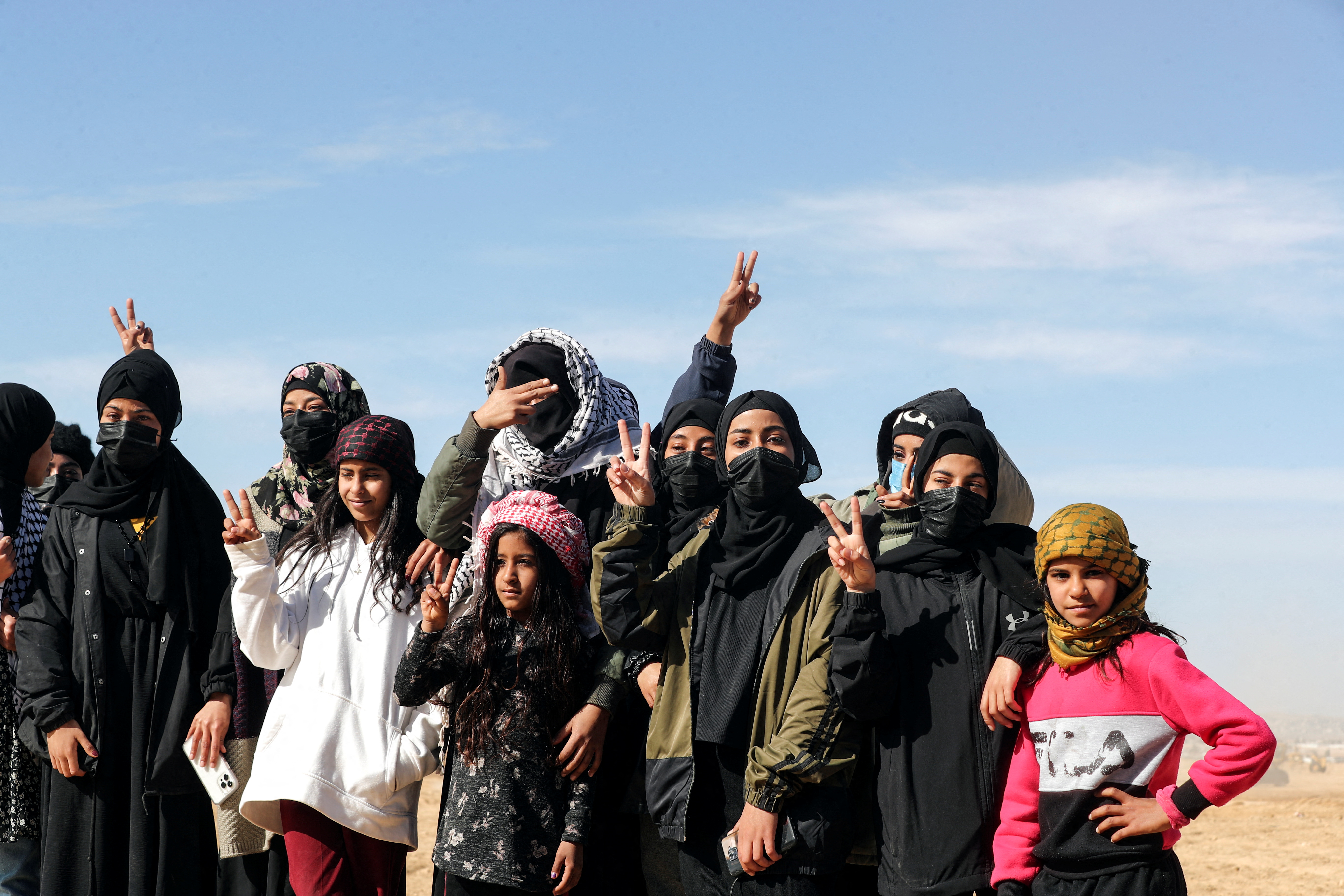 Bedouin women and girls gesture during a protest against forestation at the Negev desert village of Sawe al-Atrash, southern Israel