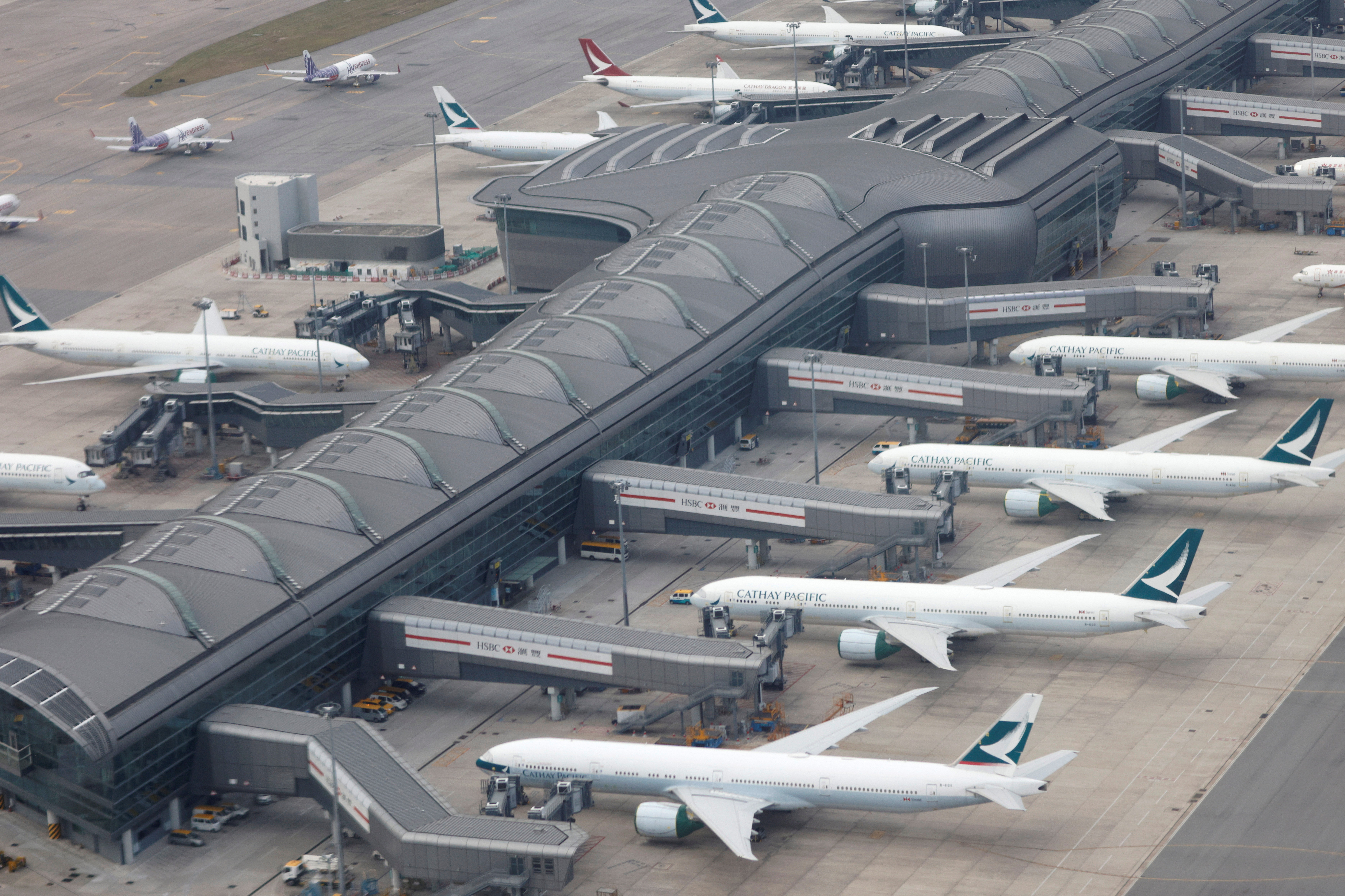 Aircrafts of Cathay Pacific and its regional brand Cathay Dragon are parked on the tarmac at the Hong Kong International Airport, Hong Kong