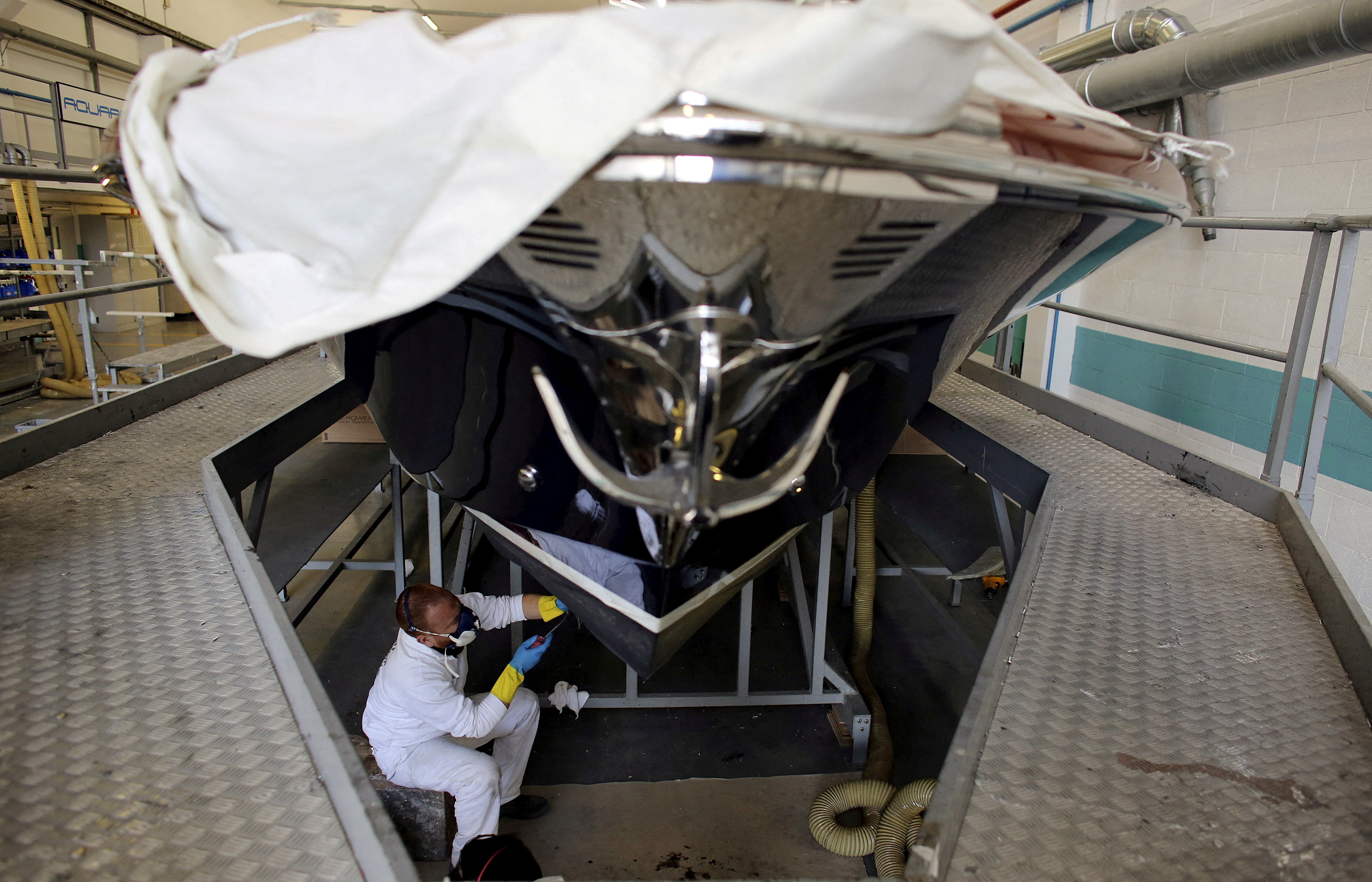 Employee works on a yacht at the Ferretti's shipyard in Sarnico