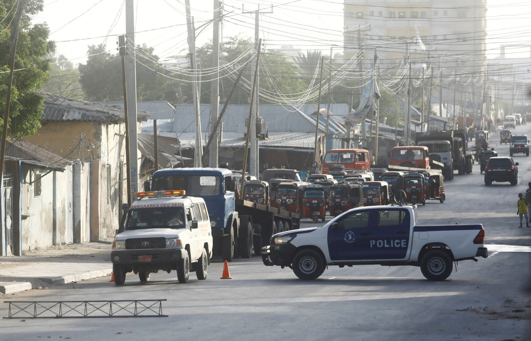 Somali security forces secure the street near the scene of a militant attack at a building in Abdias district of Mogadishu
