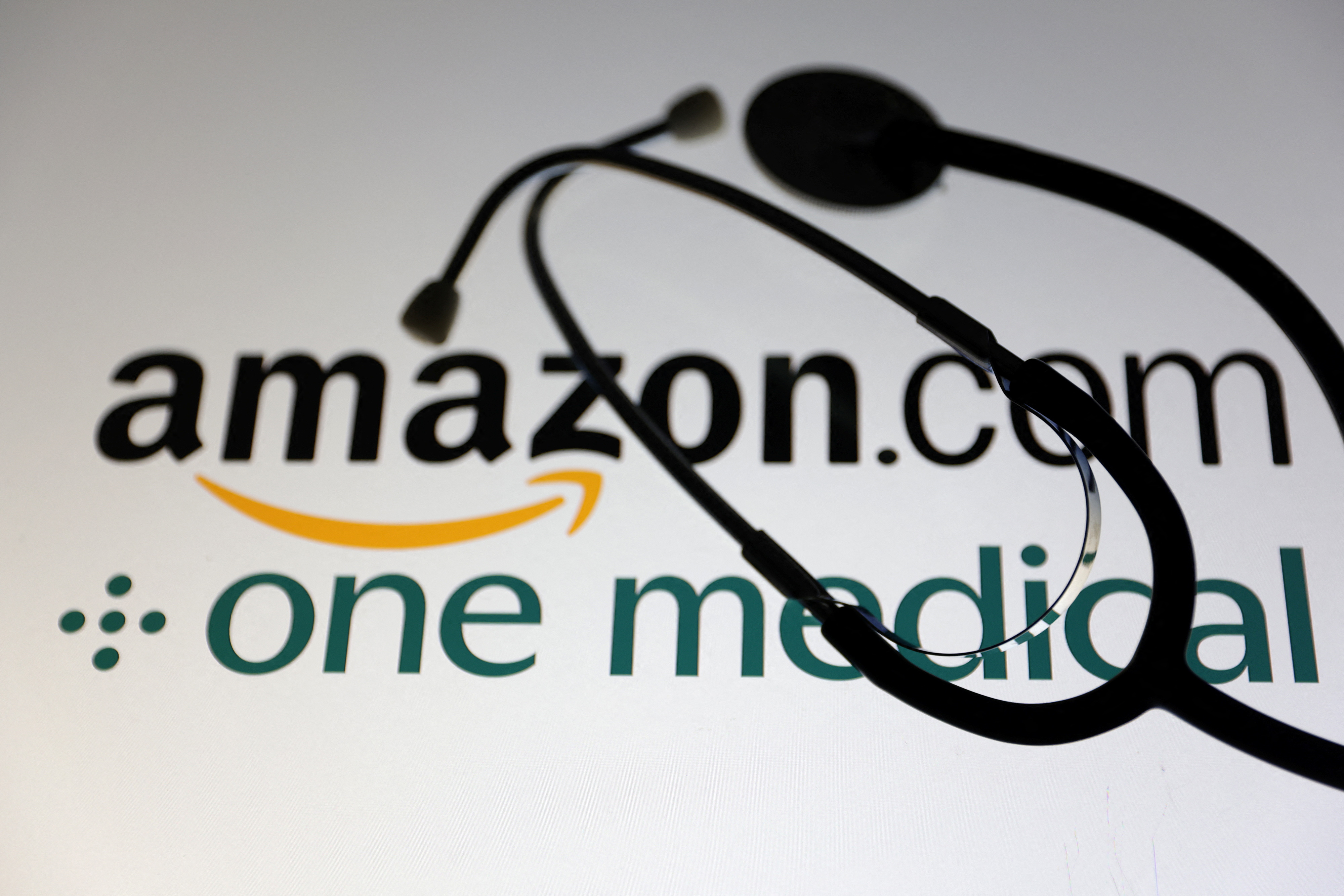 Illustration shows Amazon.com and One Medical logos