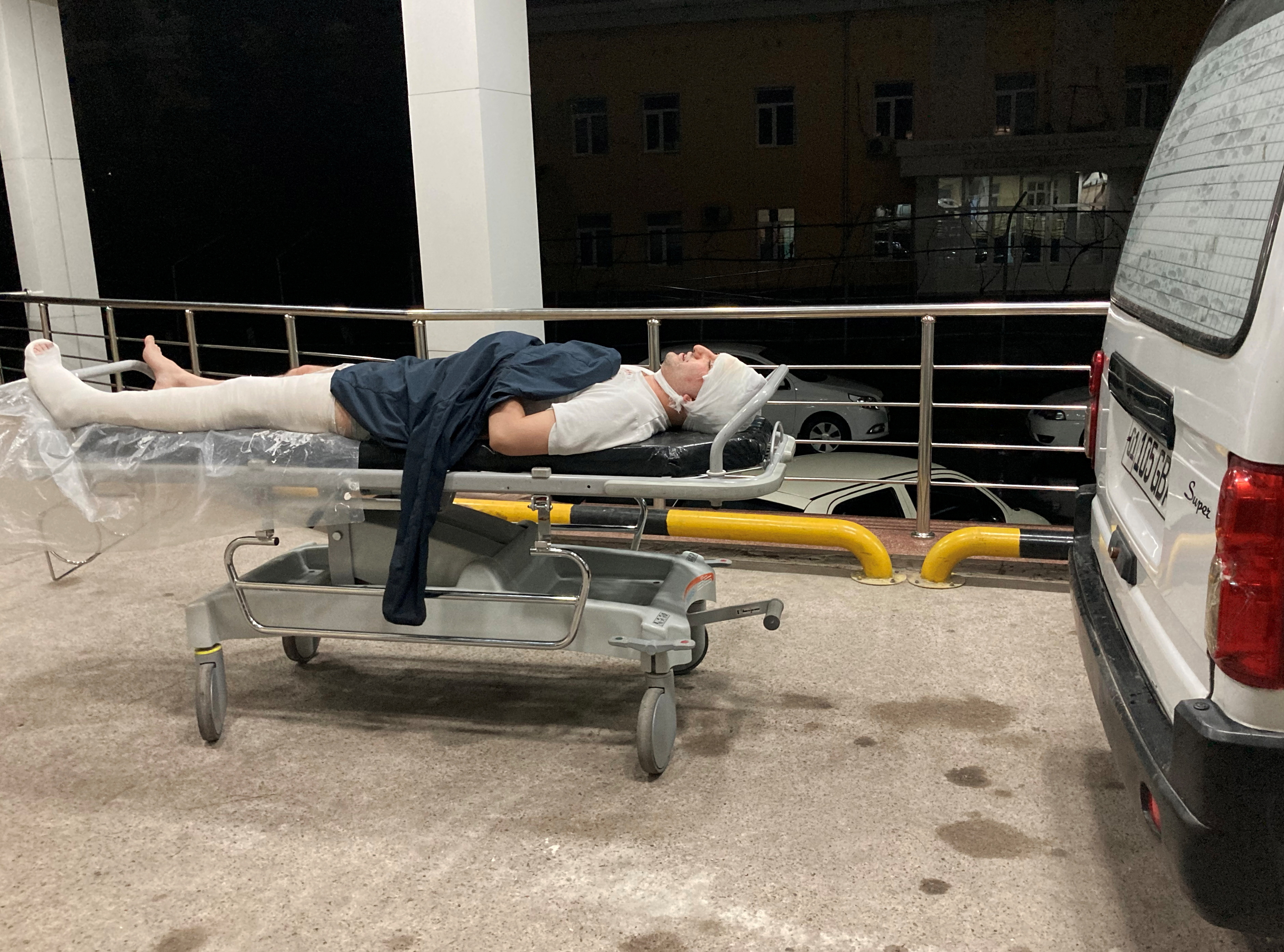 Blogger Miraziz Bazarov lies on a stretcher upon his arrival at a hospital after he was beaten in Tashkent