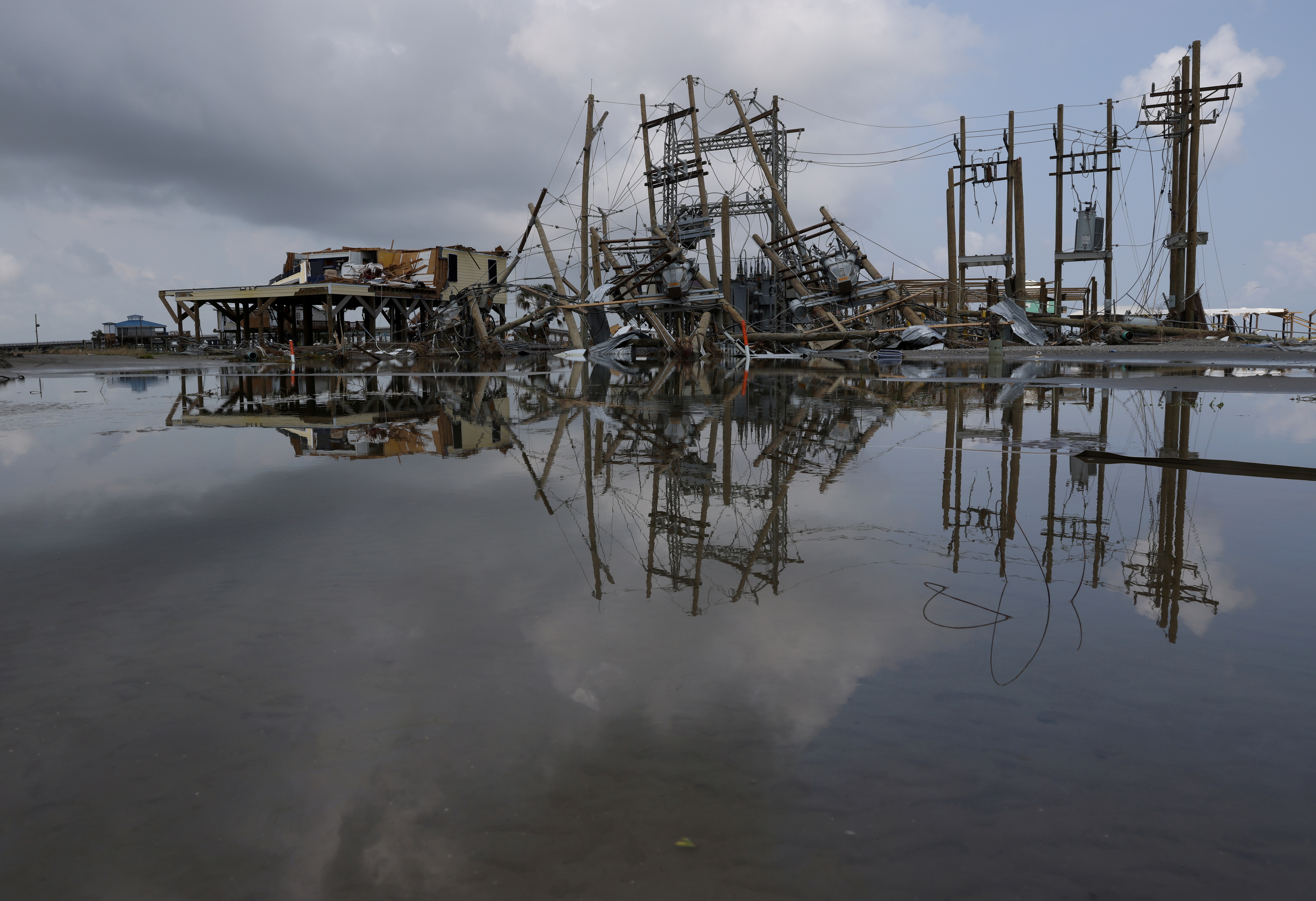Damaged power lines and homes can be seen days after hurricane Ida ripped through Grand Isle, Louisiana, U.S., September 2, 2021. REUTERS/Leah Millis
