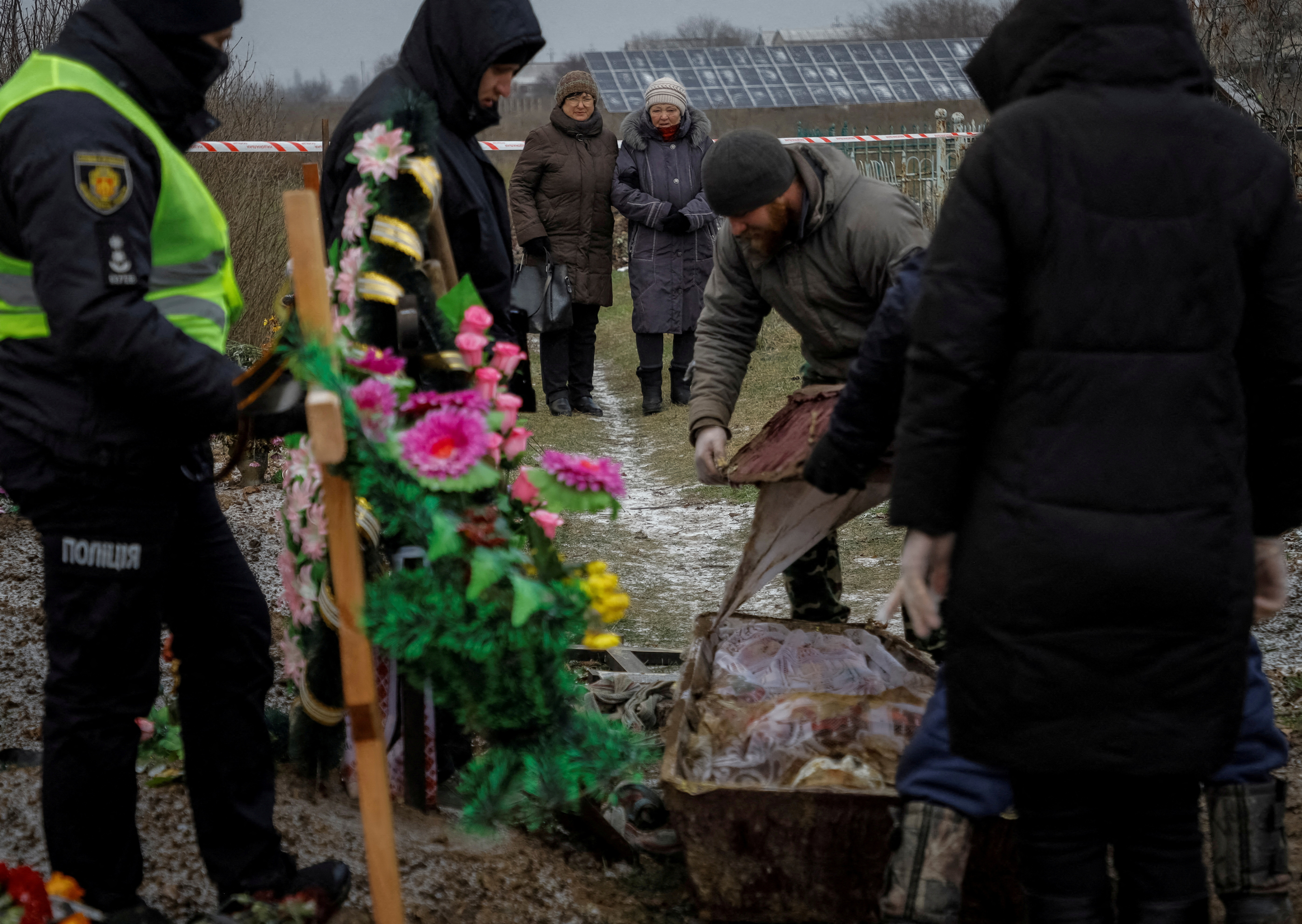 Tamila Pehyda attends an exhumation of her husband Serhii, who was killed by shrapnel during a Russian missiles attack on June 21 in the village of Vysokopillia