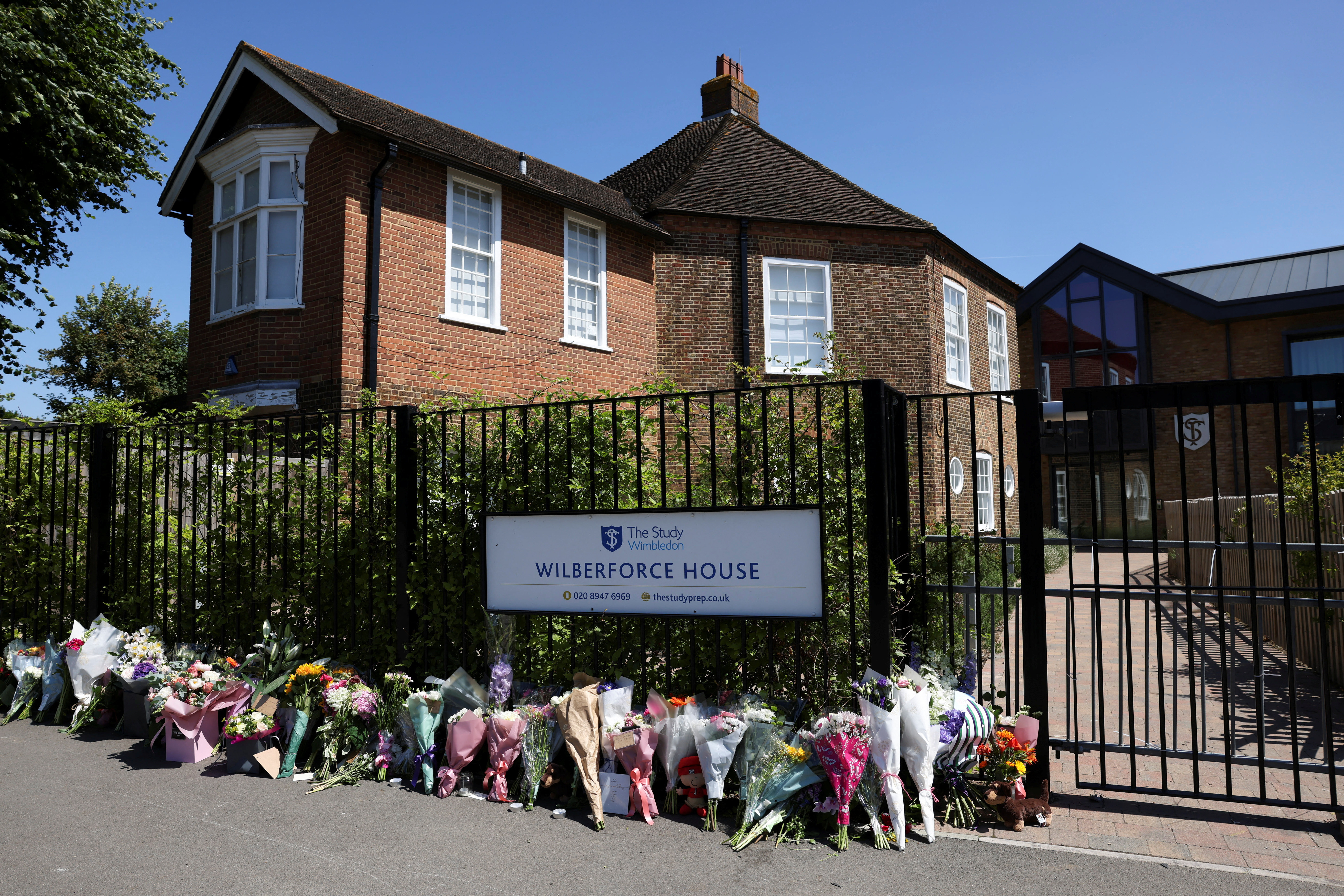 People lay flowers outside The Study Preparatory School in Wimbledon