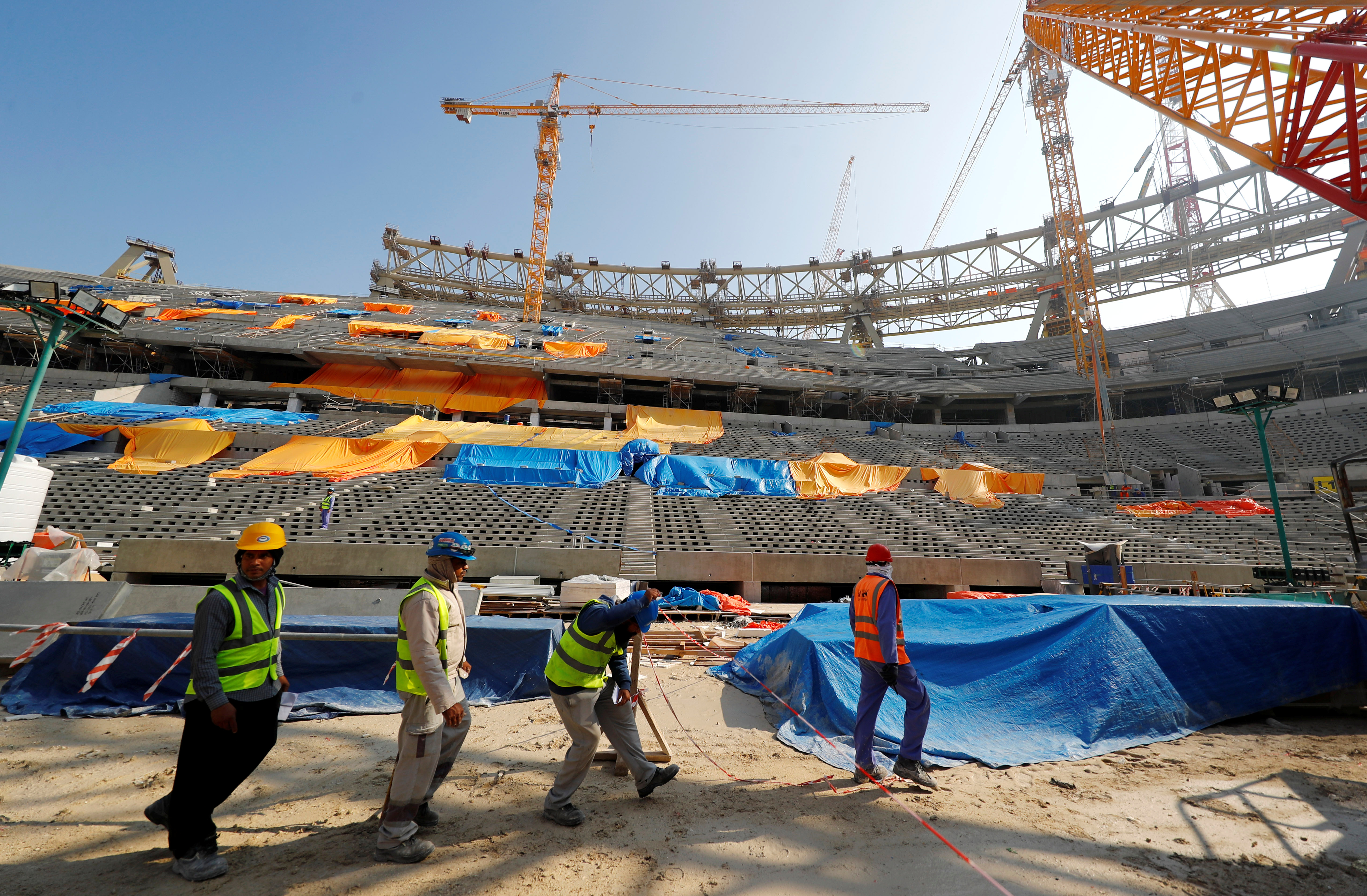 Workers are seen inside the Lusail stadium which is under construction for the upcoming 2022 Fifa soccer World Cup during a stadium tour in Doha
