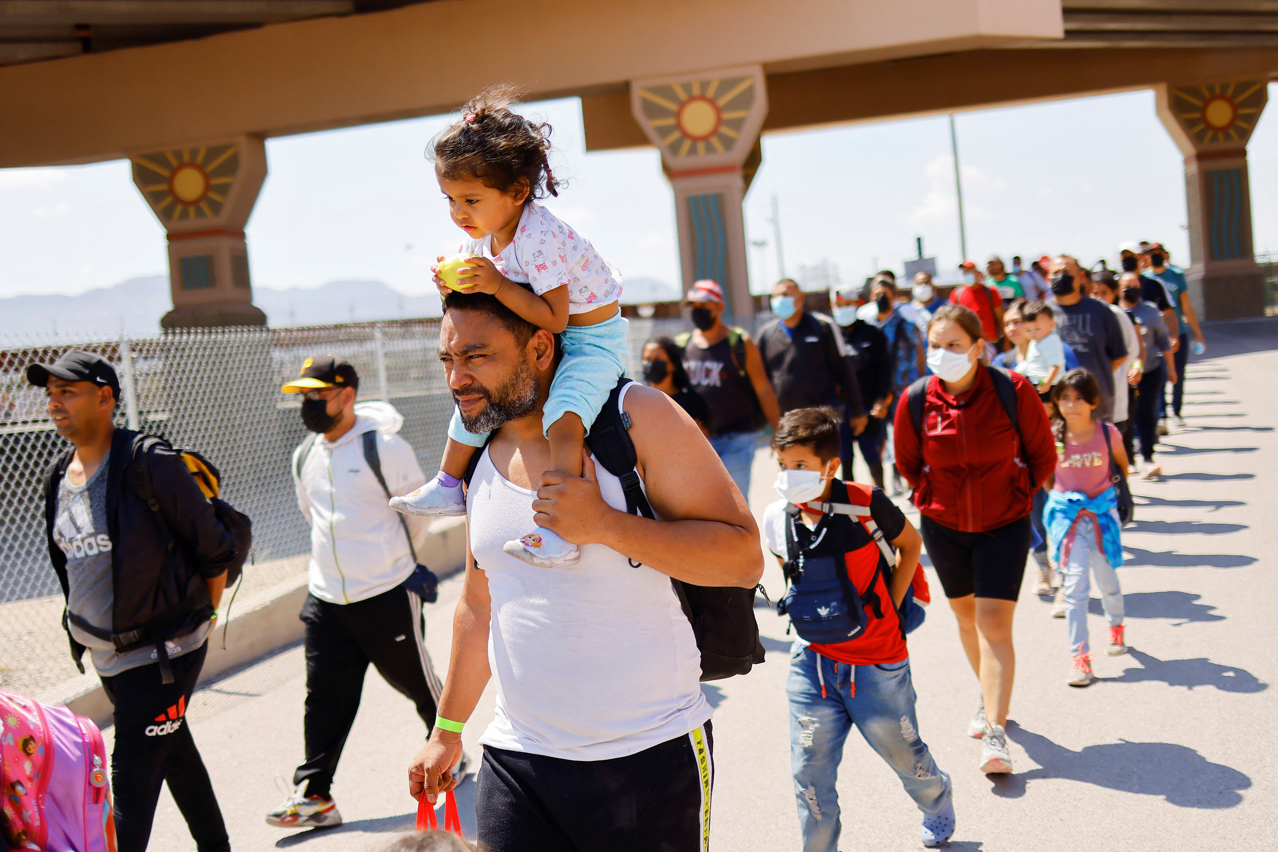 Migrants walk after being detained by U.S. Border Patrol agents after crossing into the United States from Mexico to turn themselves in to request for asylum, in El Paso