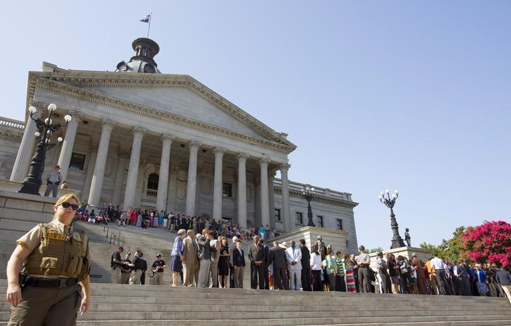 People gather on the steps of the South Carolina statehouse before a ceremony to remove the Confederate battle flag from the South Carolina statehouse grounds in Columbia, South Carolina