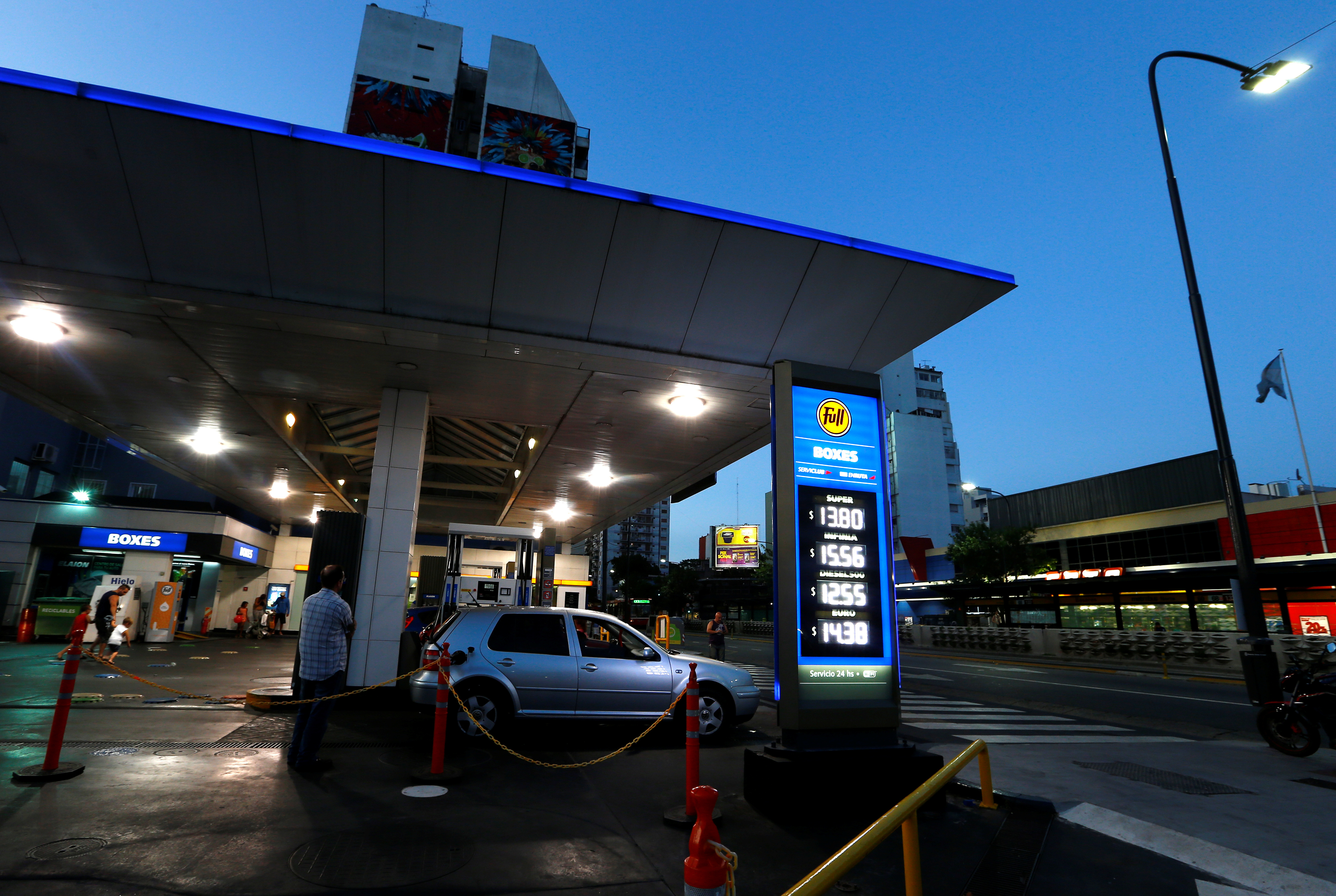 A YPF oil station displays the price of differents refined petrol and diesel per litre in Buenos Aires