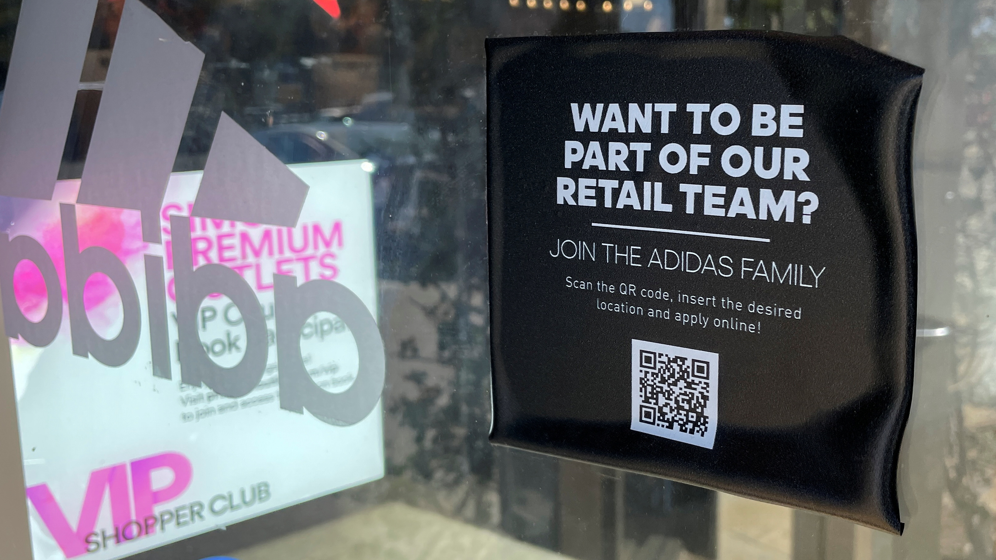 A job posting is shown on the window of a retail store looking for seasonal workers at a shopping mall in Carlsbad, California