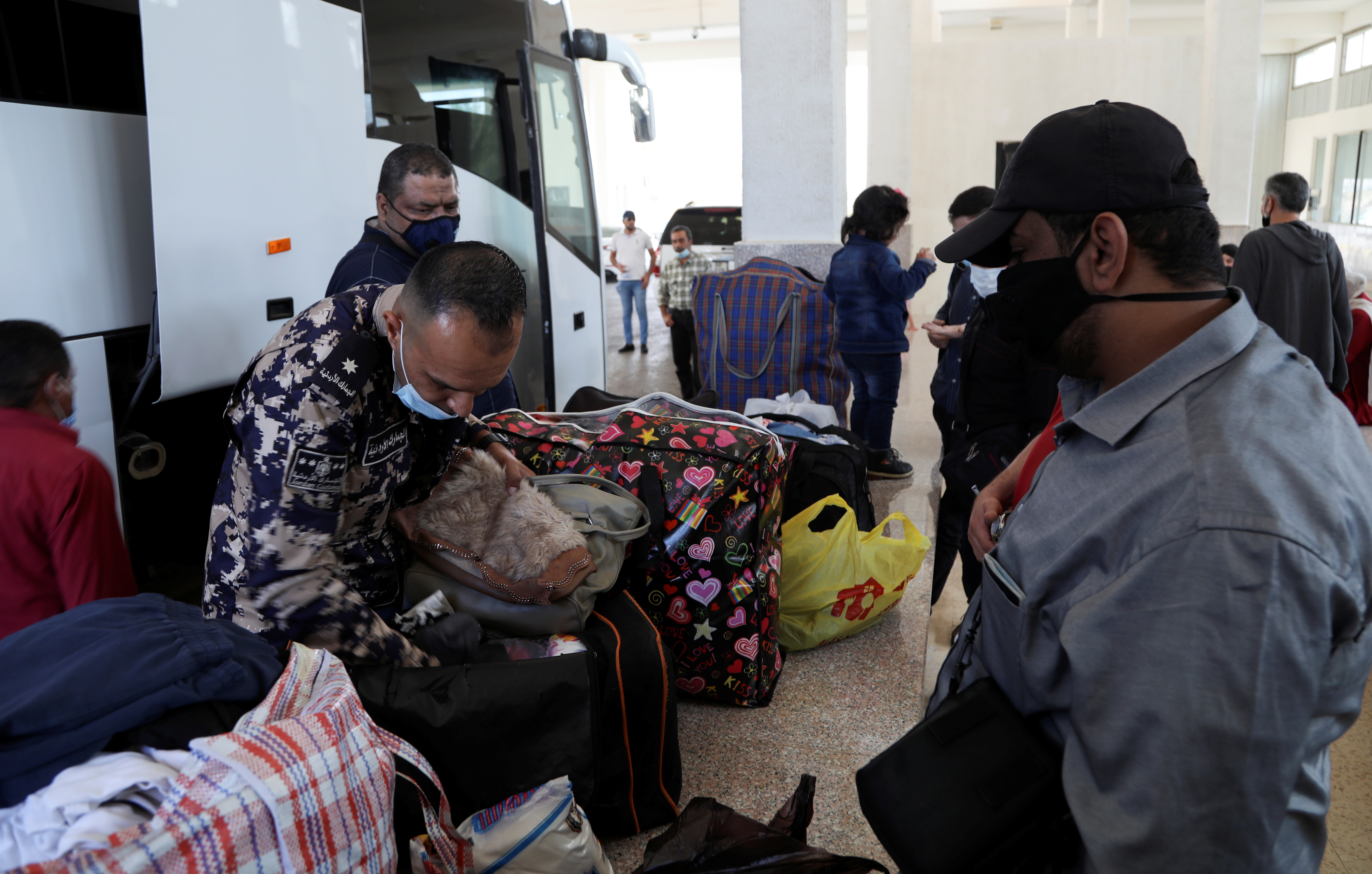 A customs officer inspects travellers'  belongings at Jaber border crossing with Syria, near Mafraq