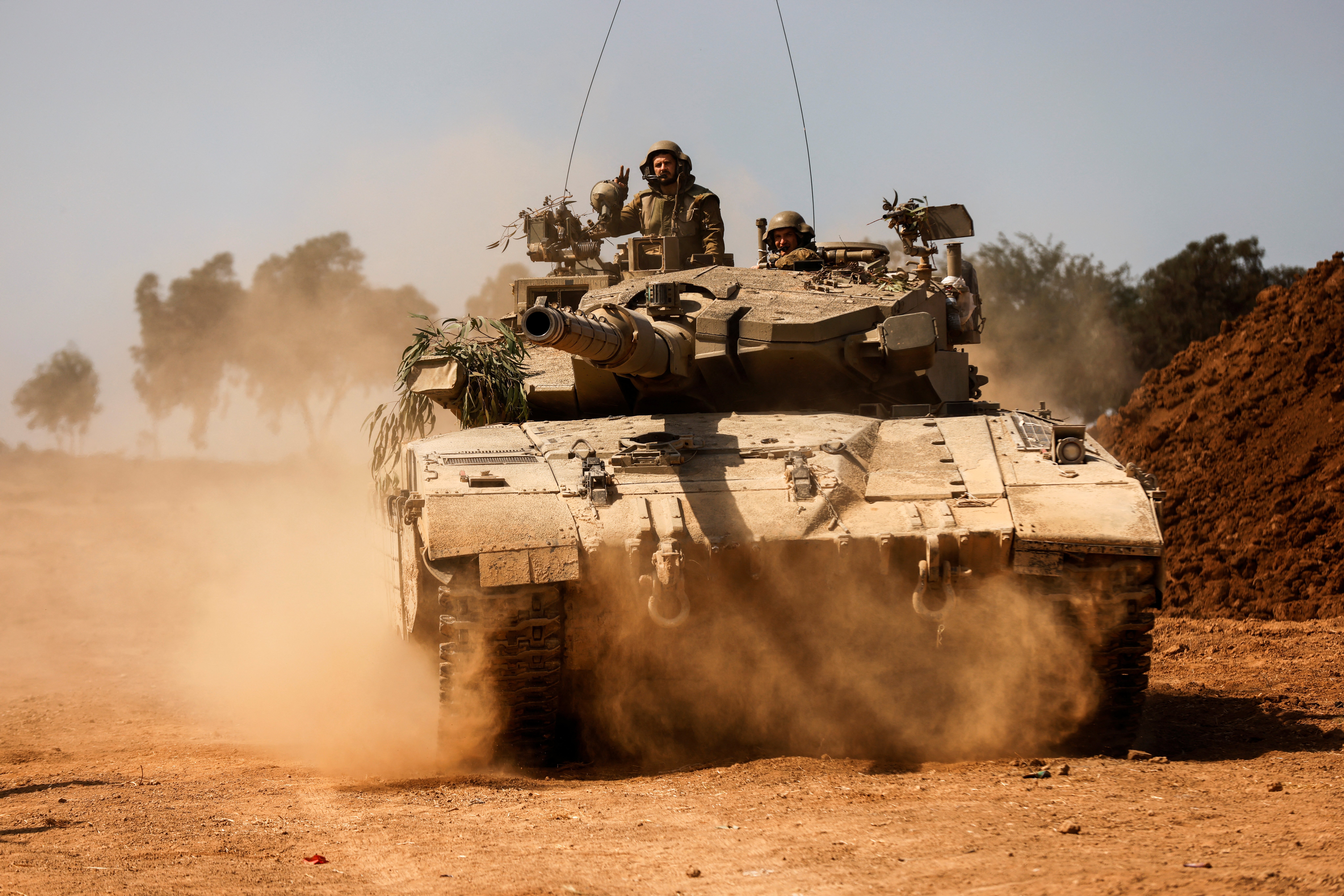 An Israeli tank takes position near Israel's border with the Gaza Strip, in southern Israel