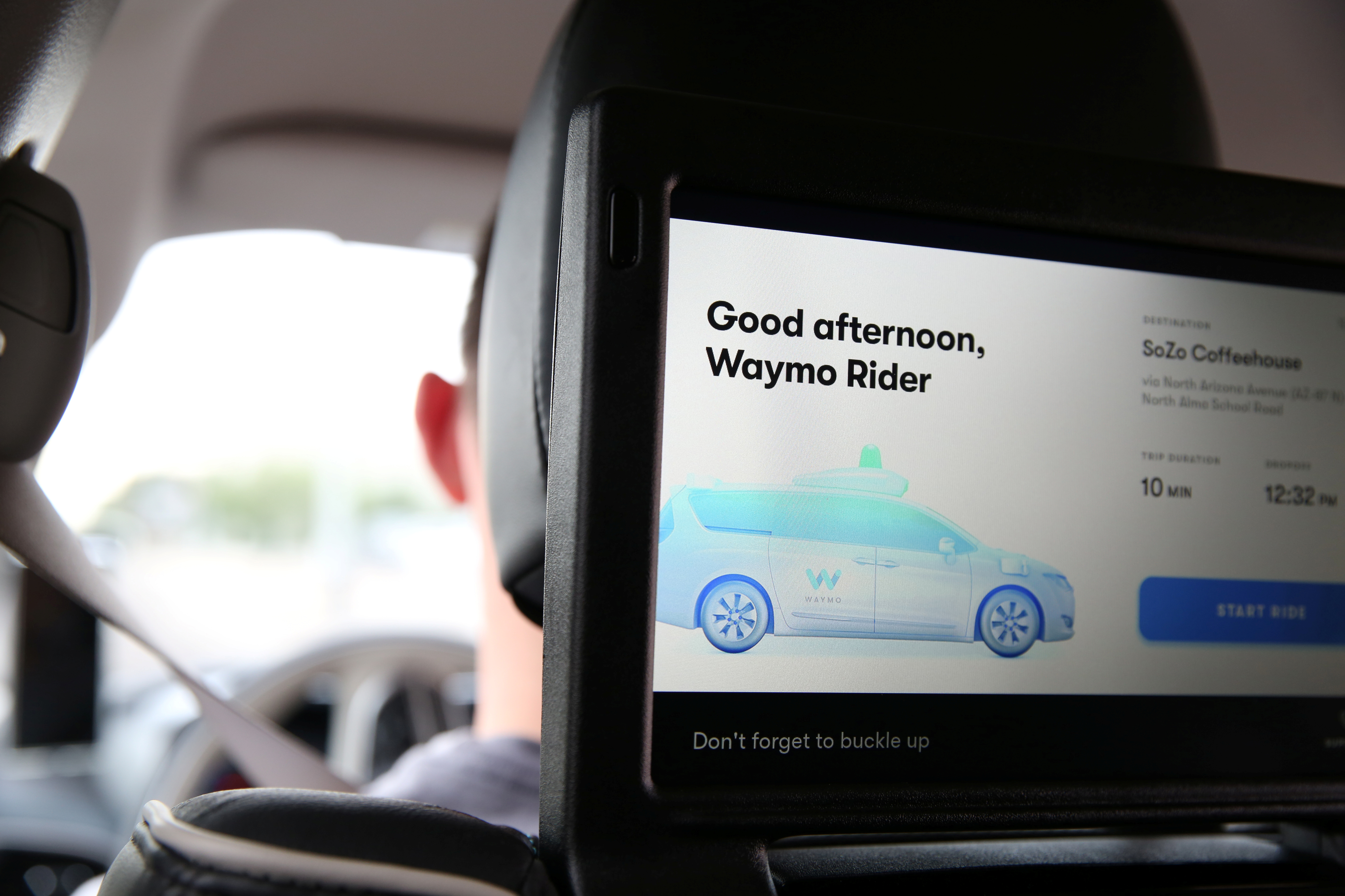 One of three screens displays the user interface inside a Waymo self-driving vehicle, during a demonstration in Chandler, Arizona