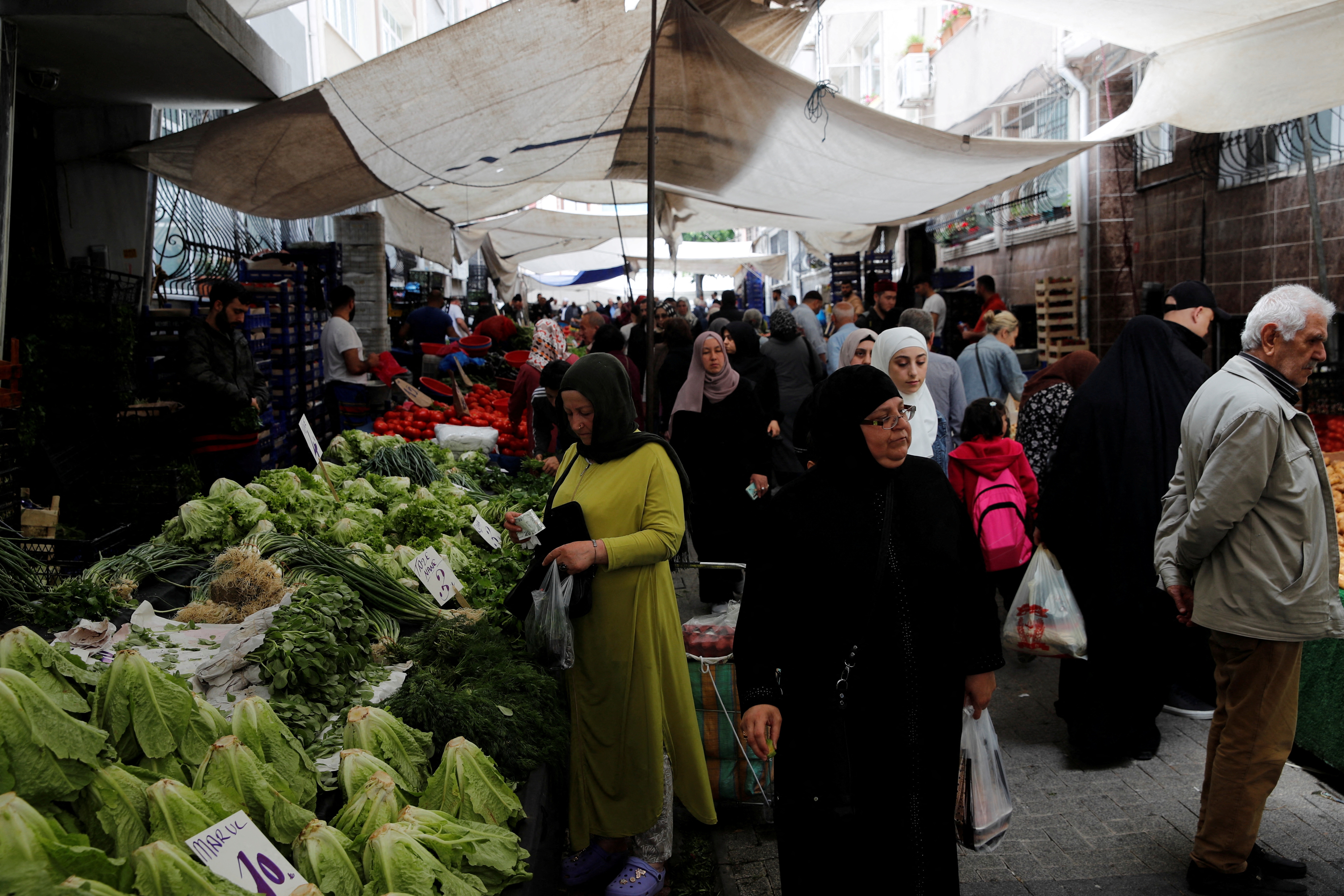 People shop at a market in Istanbul