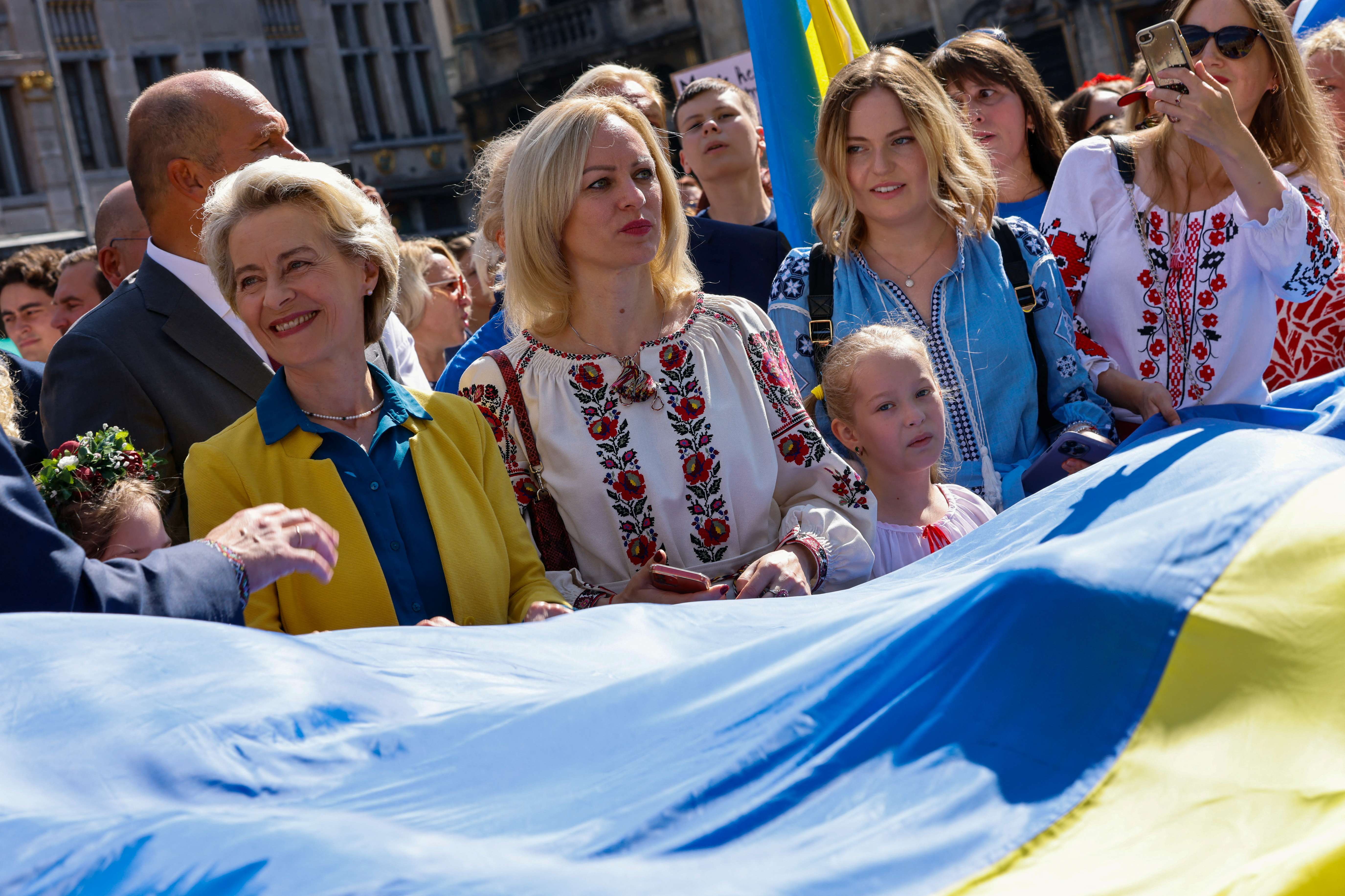 People carry a huge Ukrainian flag at the Grand Place in Brussels