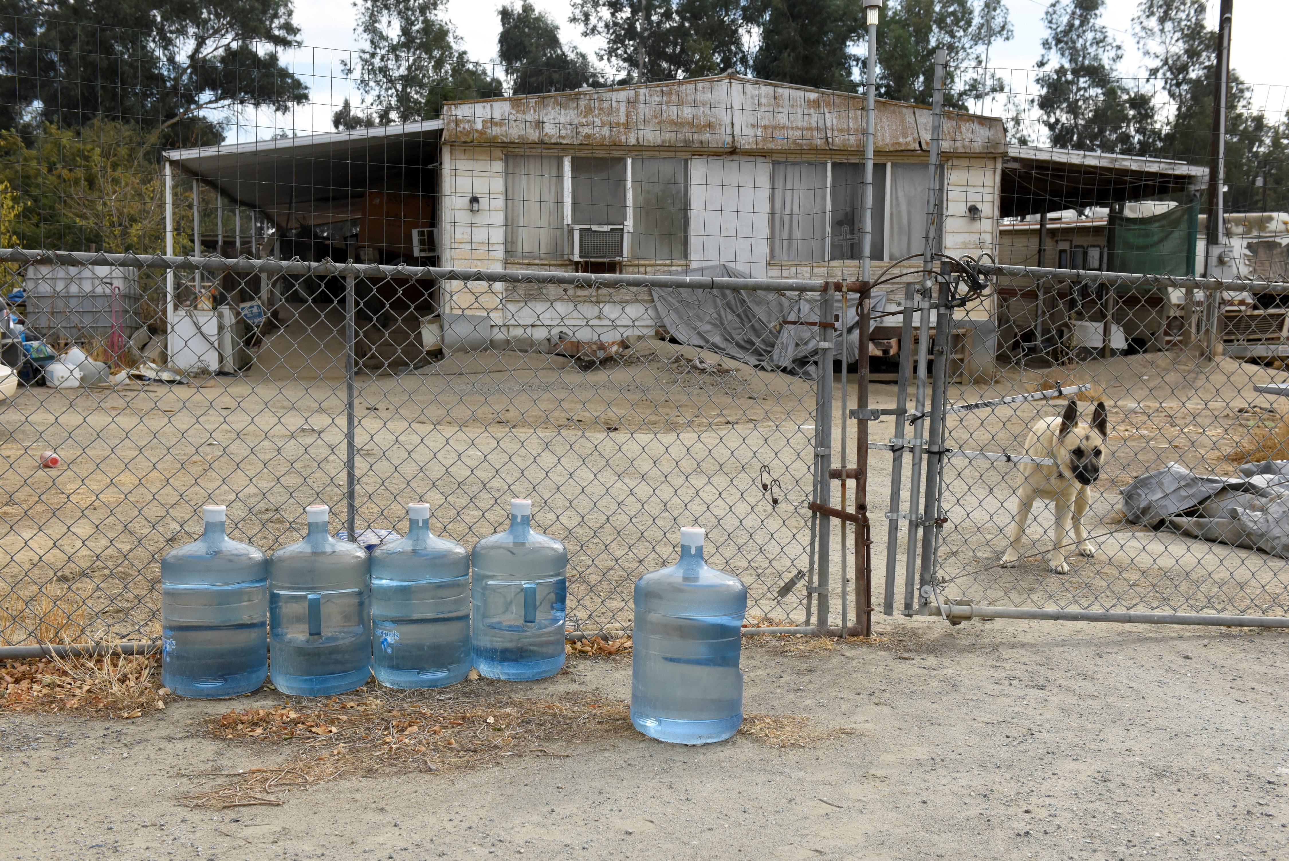 Water bottles filled with drinking water sit outside of a home in Teviston, California, U.S., October 20, 2021. Because the drinking water in Teviston is contaminated, the community provides an allotment of fresh drinking water to the residents. Picture taken on October 20, 2021. REUTERS/Stephanie Keith