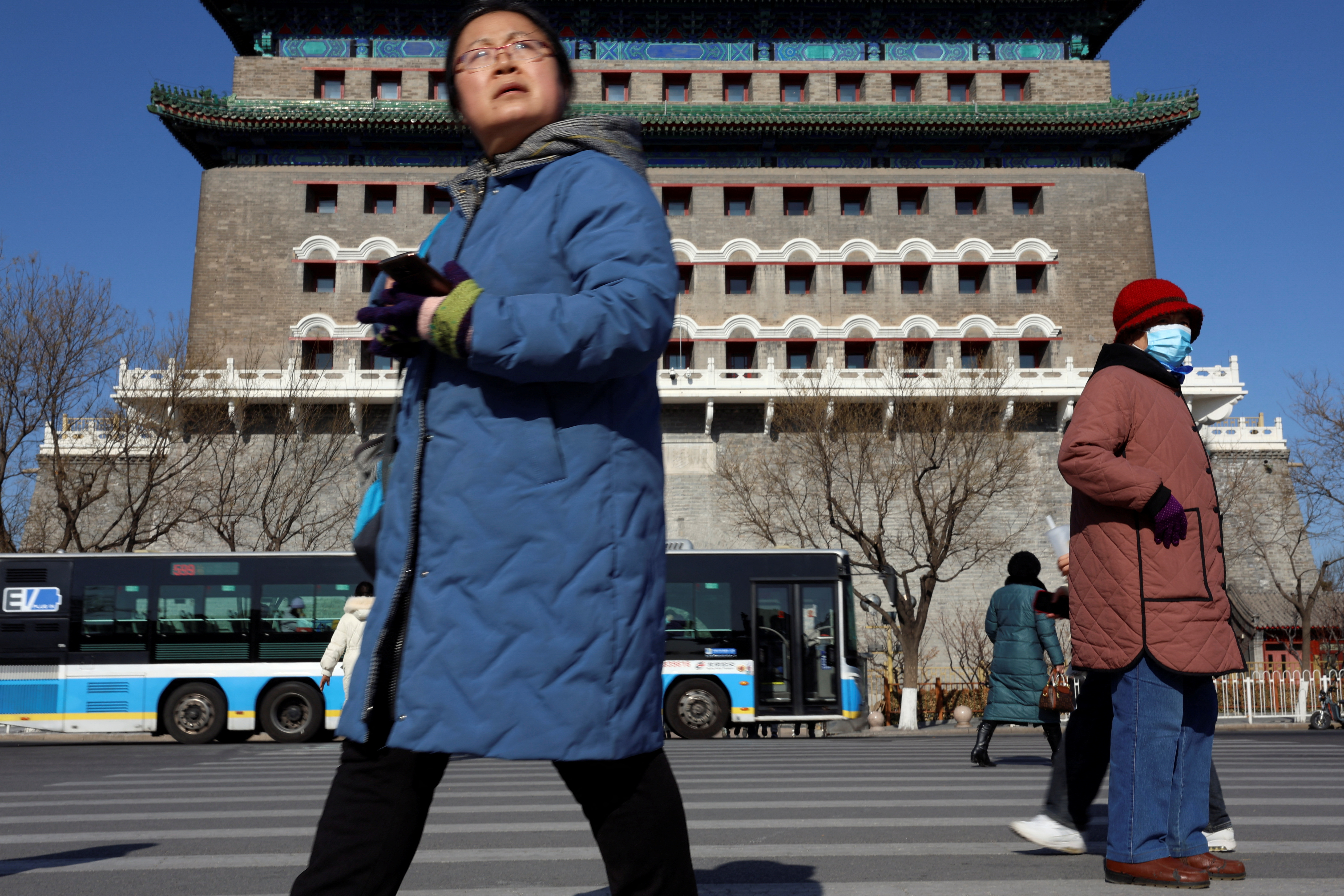 Pedestrians walk on a crossing near the Qianmen Gate in Beijing