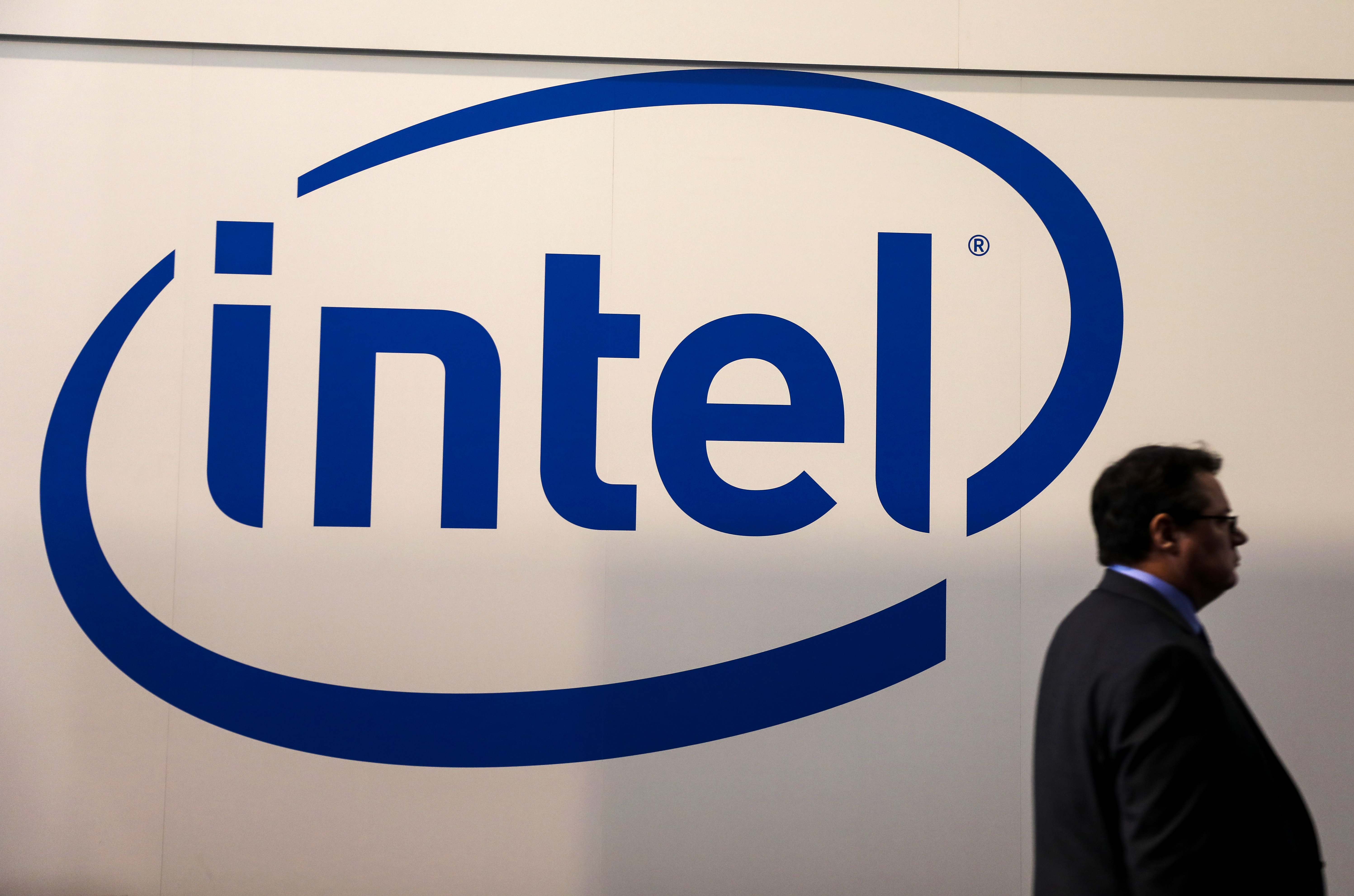 A visitor passes an Intel logo at the Mobile World Congress in Barcelona