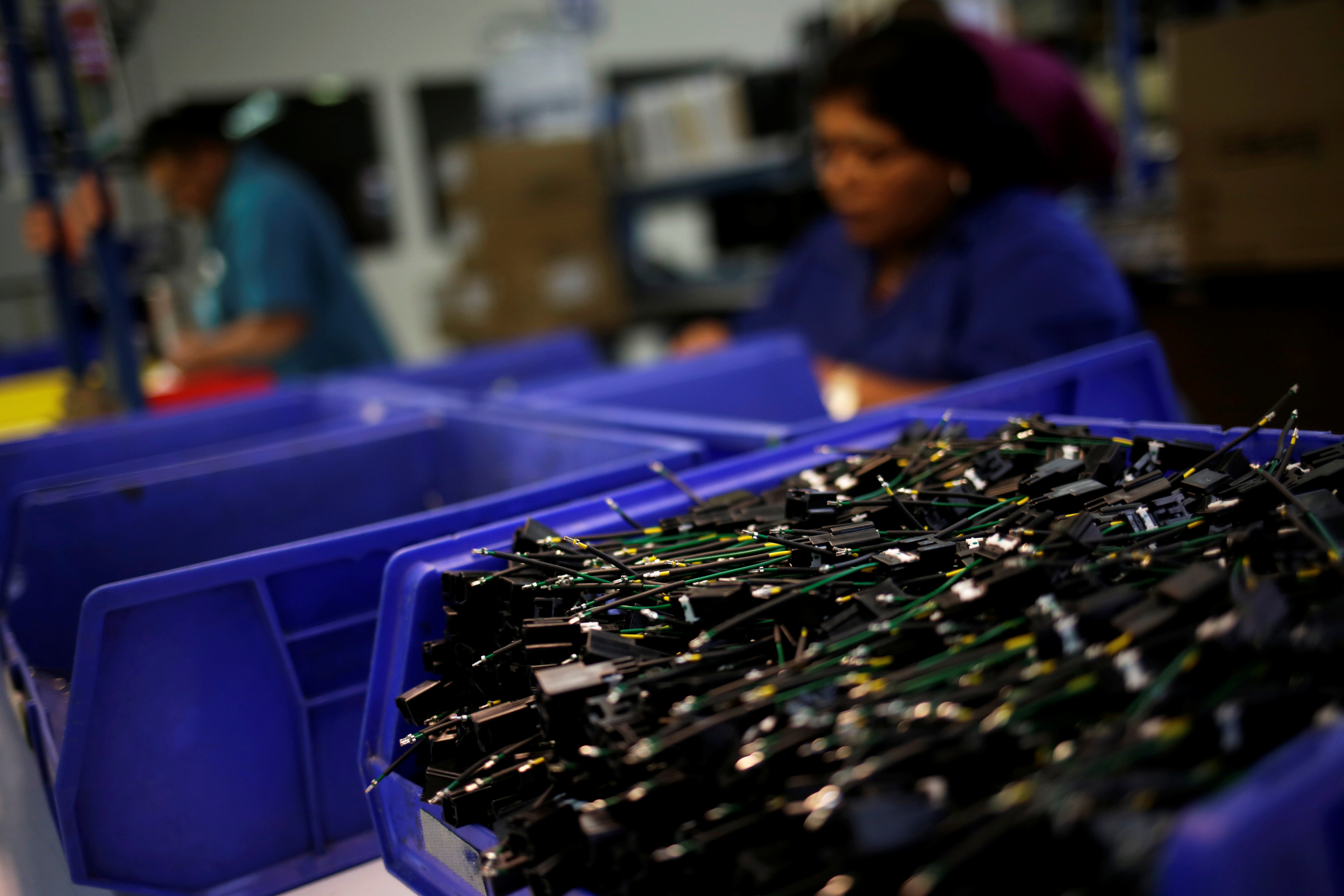 An operator works at a wire harness and cable manufacturing plant as the fast-spreading coronavirus outbreak has rippled through the global economy and upended supply chains, in Ciudad Juarez