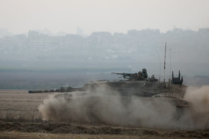 An Israeli tank manoeuvres, amid the Israel-Hamas conflict, near the Israel-Gaza border, in Israel