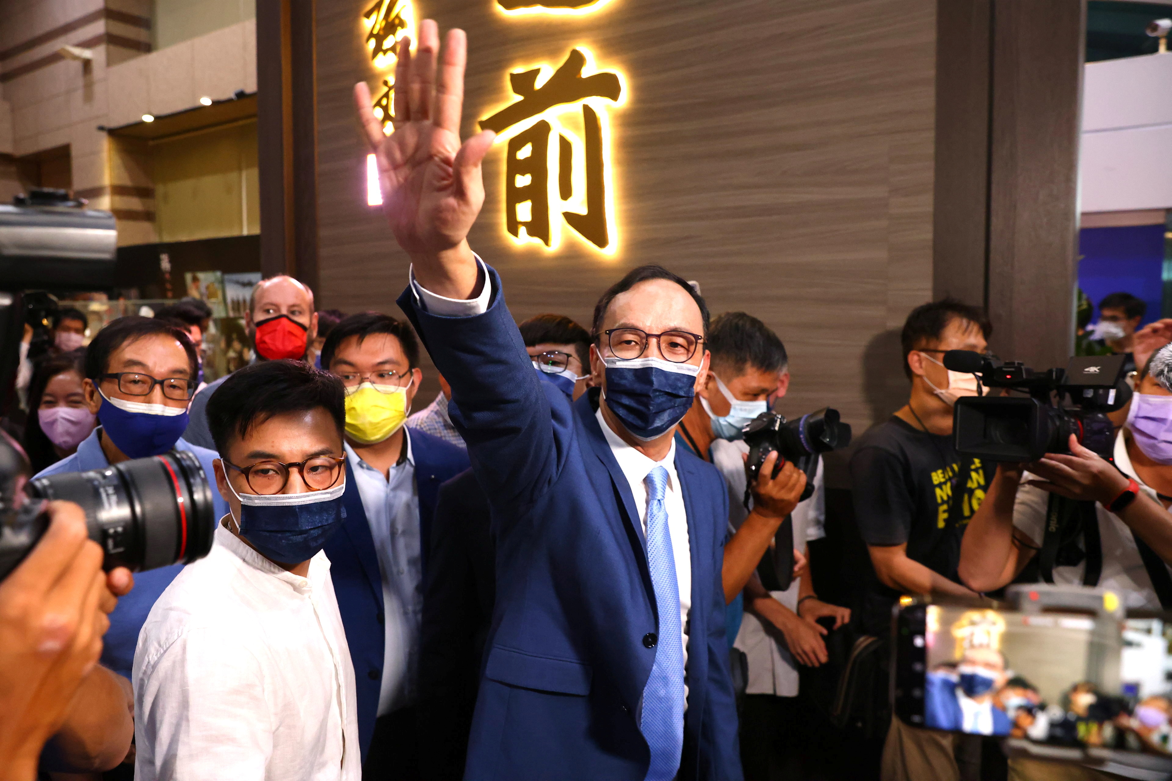 Eric Chu waves to supporters after winning chairmanship of Taiwan's main opposition KMT party, in Taipei