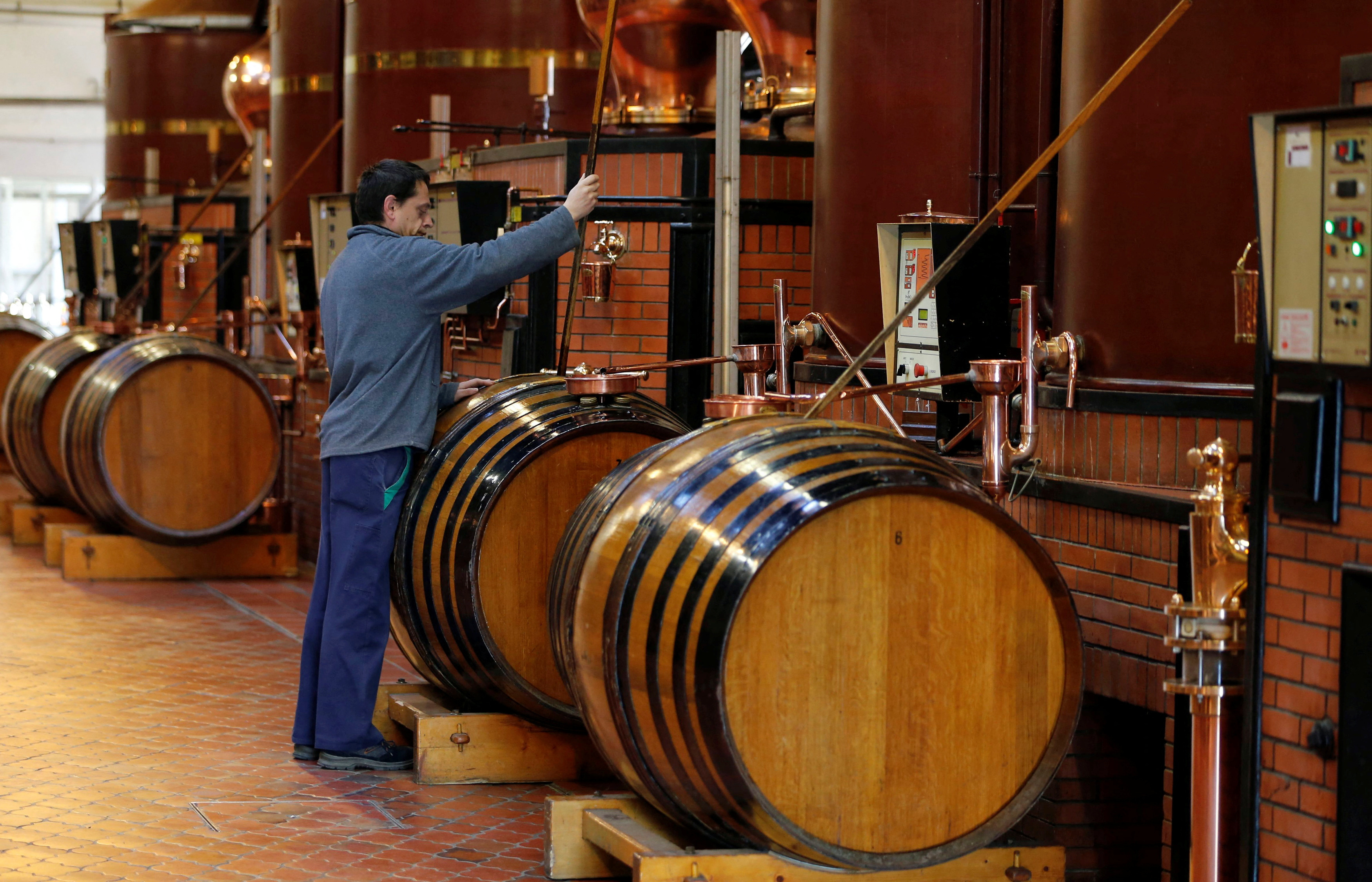 A technical expert works during a double distillation process in the distillery of Courvoisier cognac house in Cognac