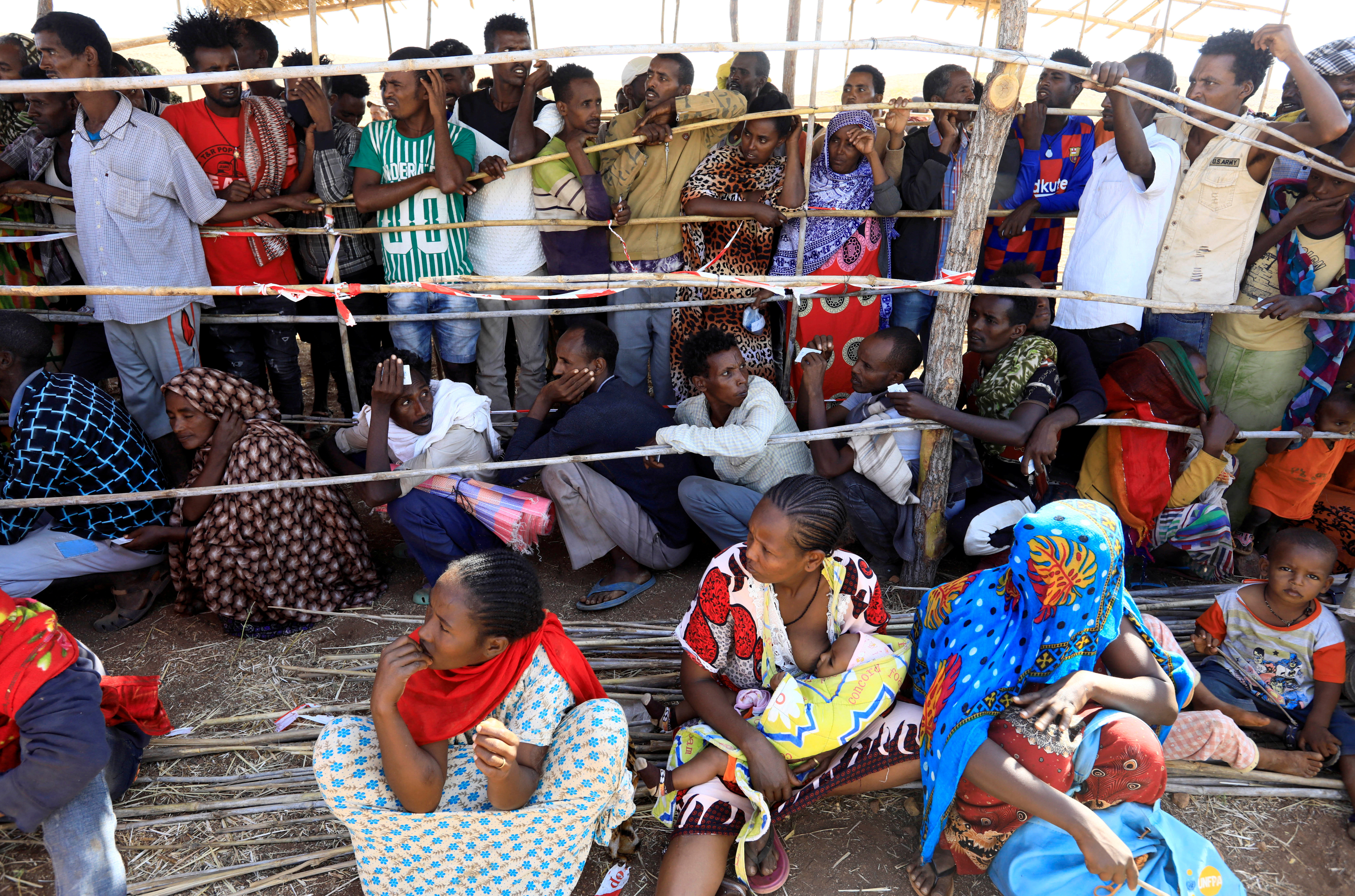 Ethiopians receive supplies at the Um-Rakoba camp on the Sudan-Ethiopia border