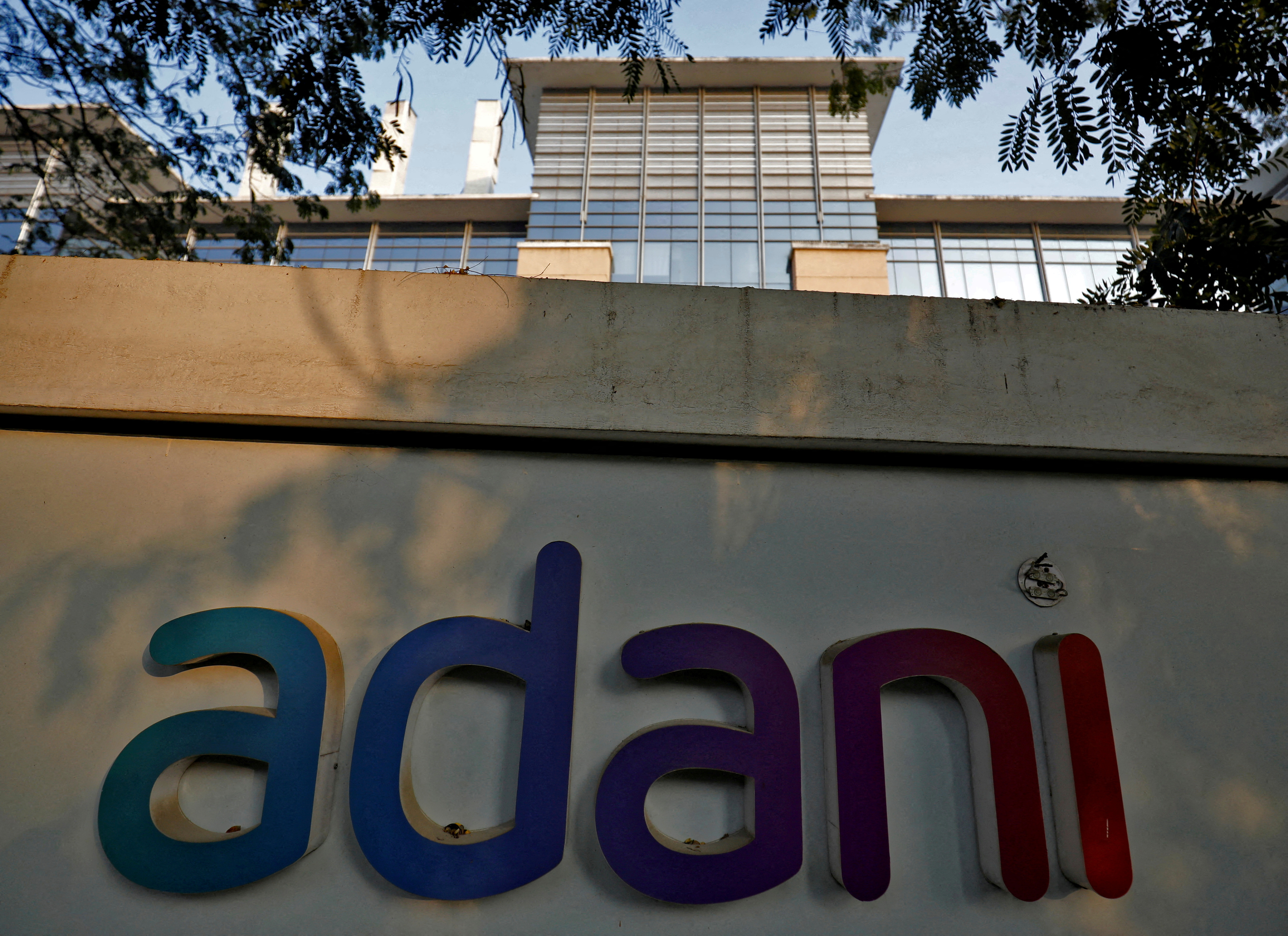 The logo of the Adani Group is seen on the wall of its realty office building on the outskirts of Ahmedabad