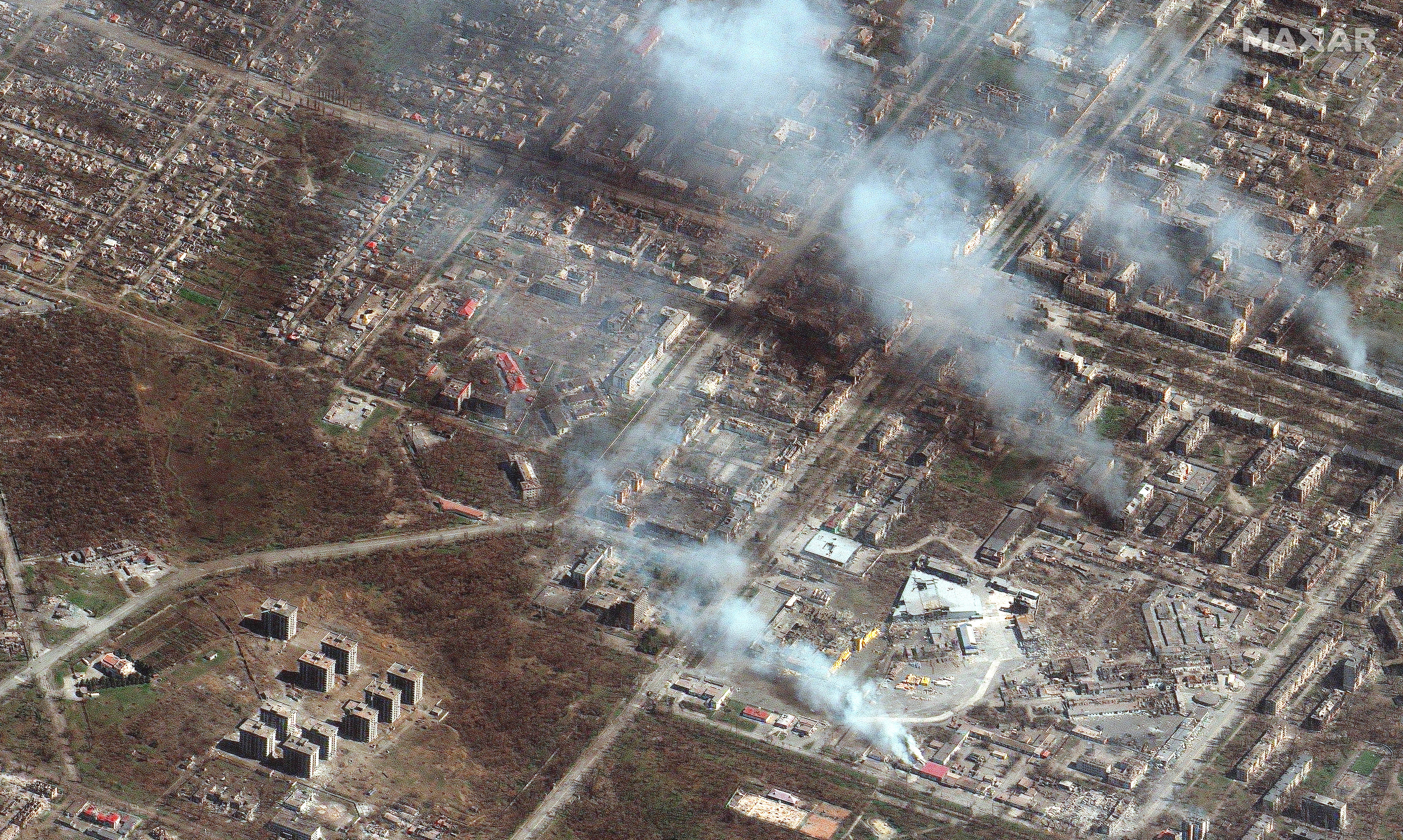 A satellite image shows buildings on fire in eastern Mariupol