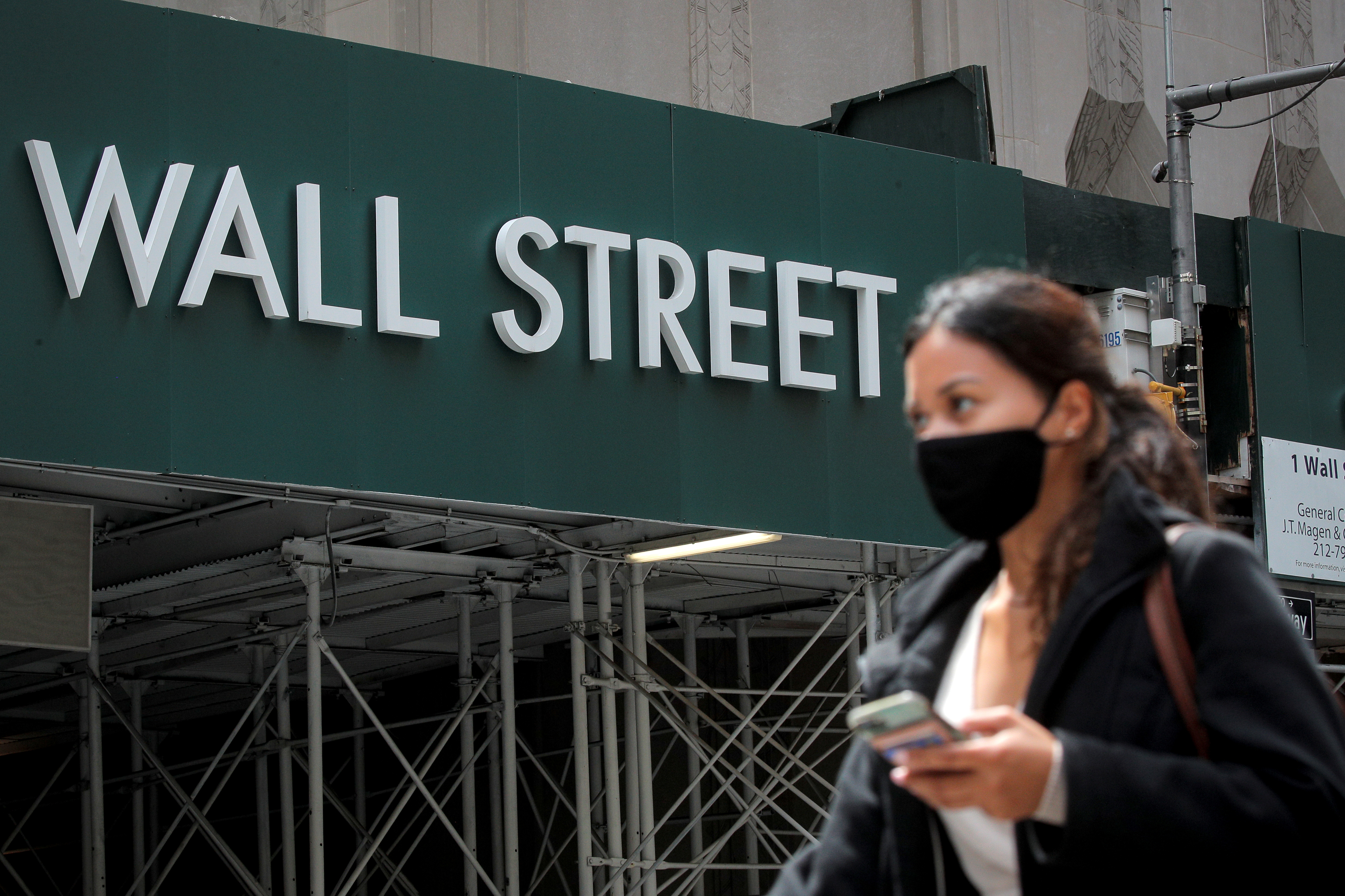 A Wall St. sign is seen near the New York Stock Exchange (NYSE) in New York City, U.S., May 4, 2021.  REUTERS/Brendan McDermid/File Photo