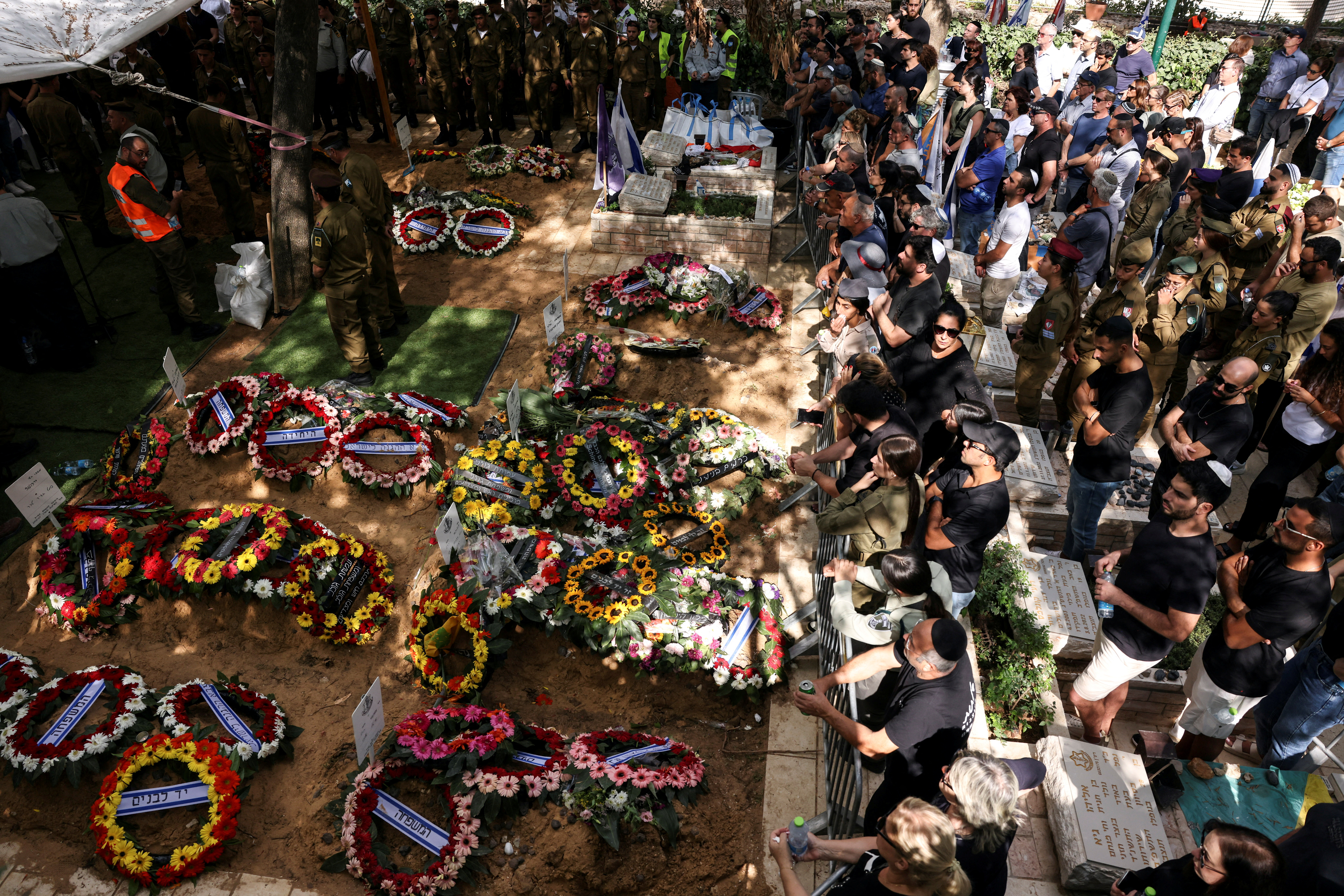 Israeli mourners attend the funerals of people who were slain in the assault on Israel by Hamas gunmen from the Gaza Strip, at Mount Herzl Military Cemetery in Jerusalem