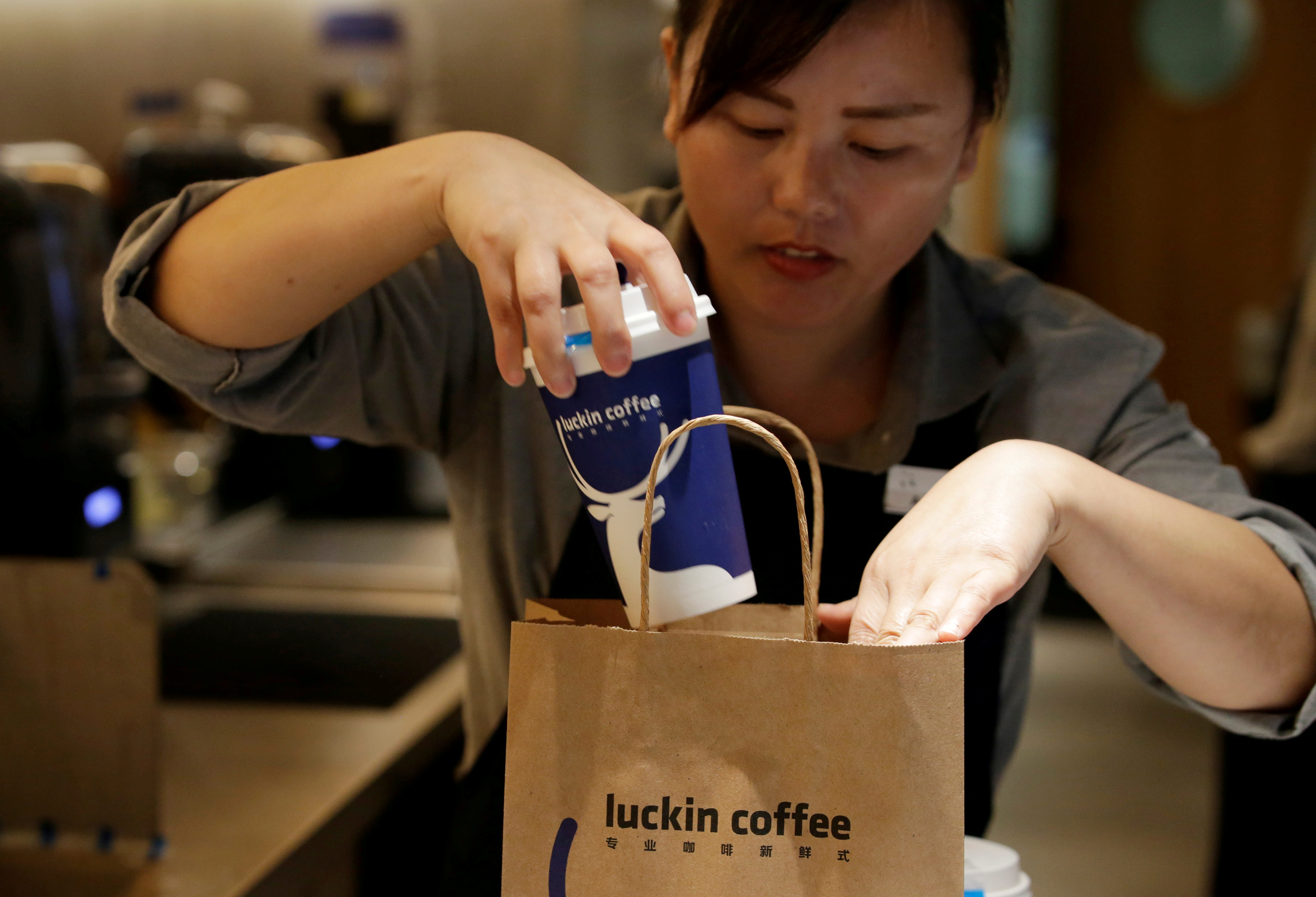 A barista packs a coffee for online sales at a Luckin Coffee store in Beijing