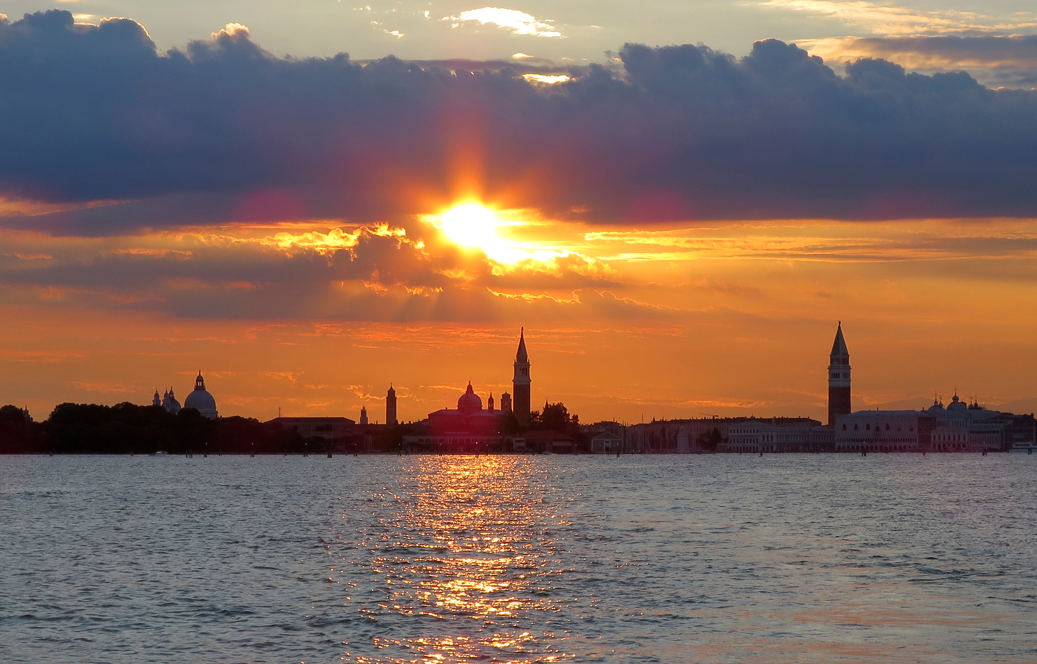 The city skyline of Venice is seen during the sun sets in the Venetian lagoon