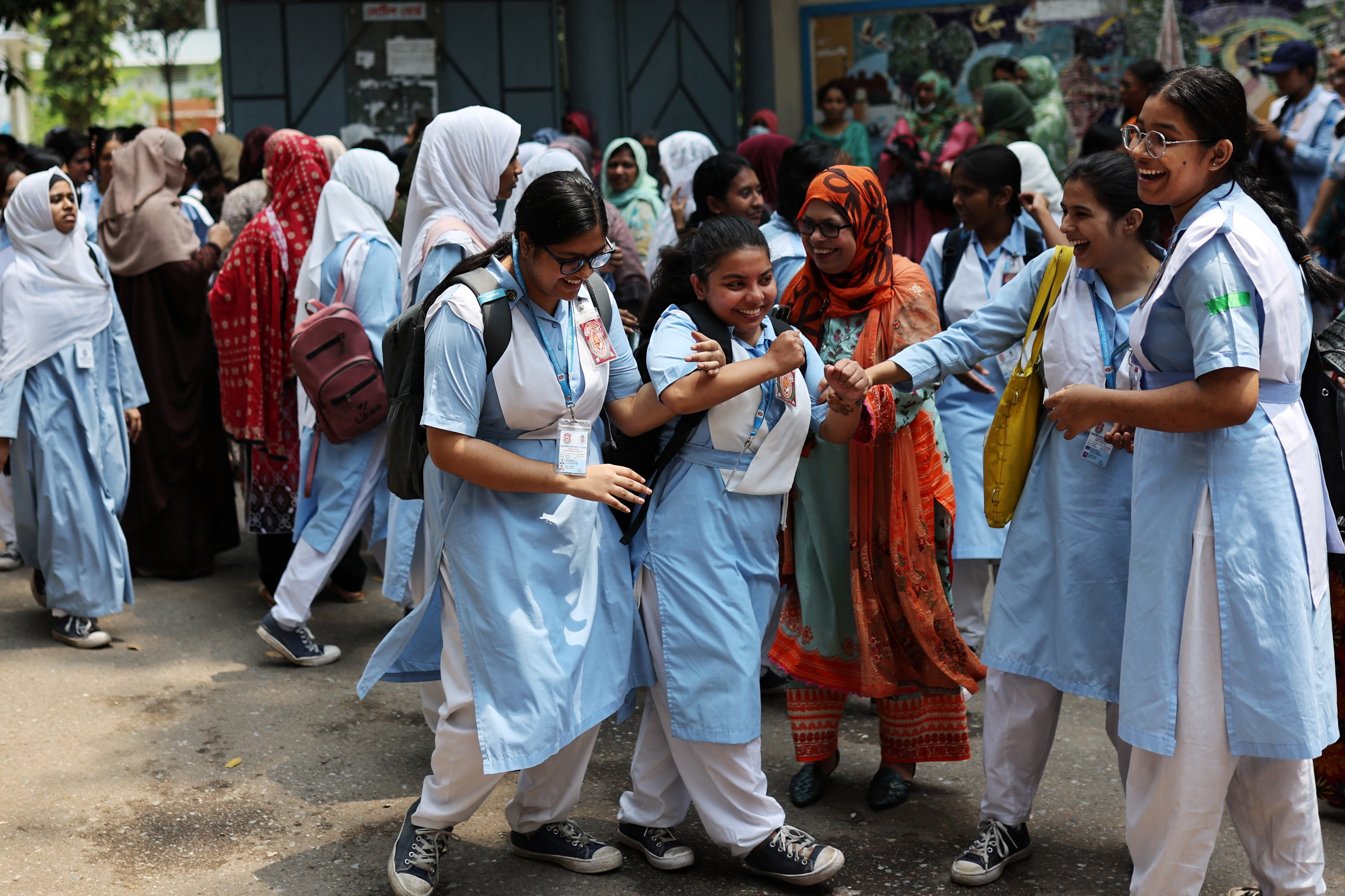 Students laugh as schools reopen after the fall in temperature, in Dhaka