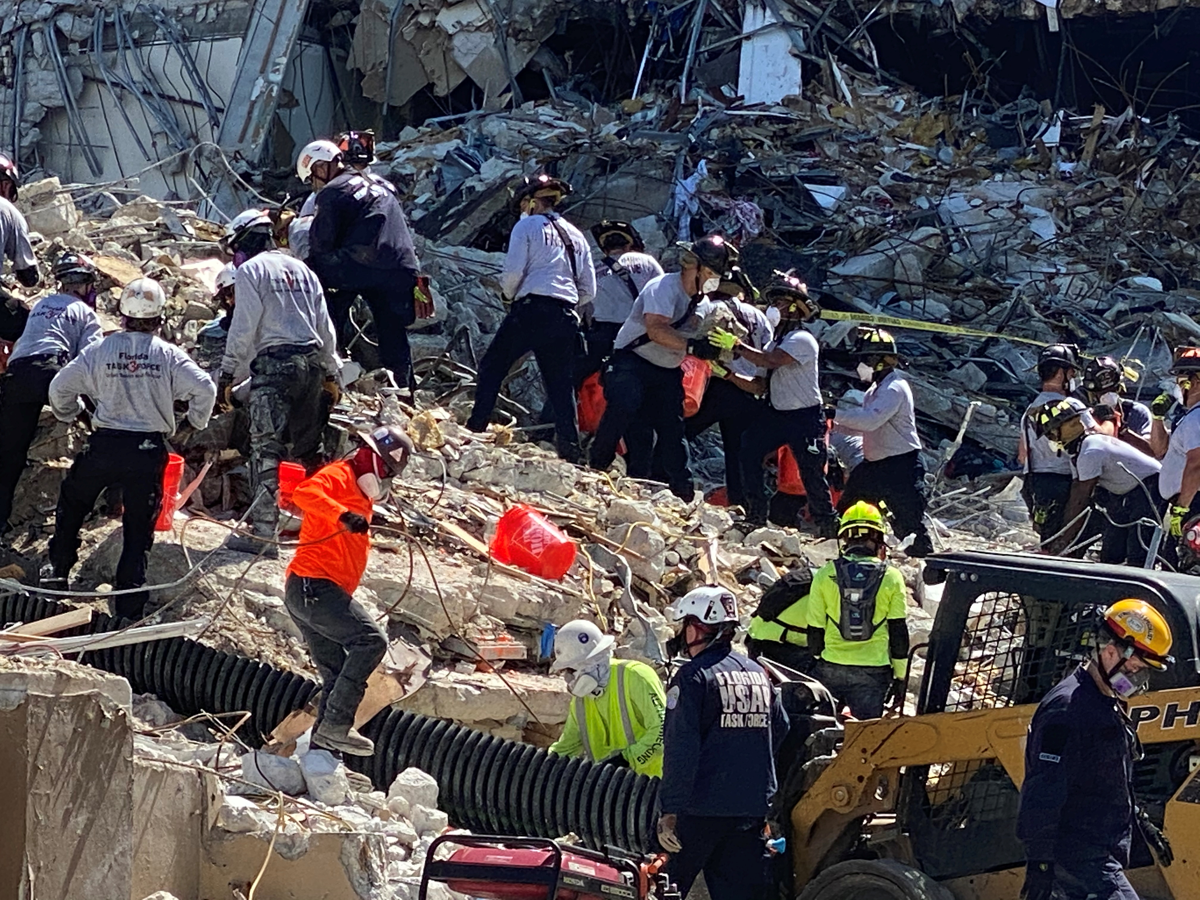 Rescue personnel work at the scene of the partially collapsed Champlain South Towers condominium in Surfside, near Miami Beach, Florida, in this undated recent photograph. Courtesy of Florida Task Force 3 / via REUTERS   
